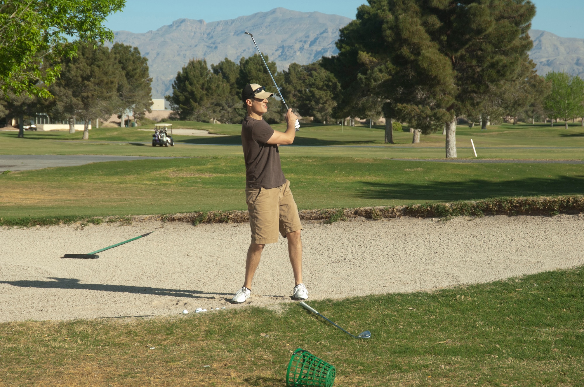 Staff Sgt. Jesse practices March 29, 2013 at the Sunrise Vista golf course on Nellis Air Force Base, Nev. Golfers come to Sunrise Vista to enjoy friendly games of golf, experience the military atmosphere, including flyovers, and taking advantage of the competitive prices. (U.S. Air Force photo by Caitlin Kenney)
