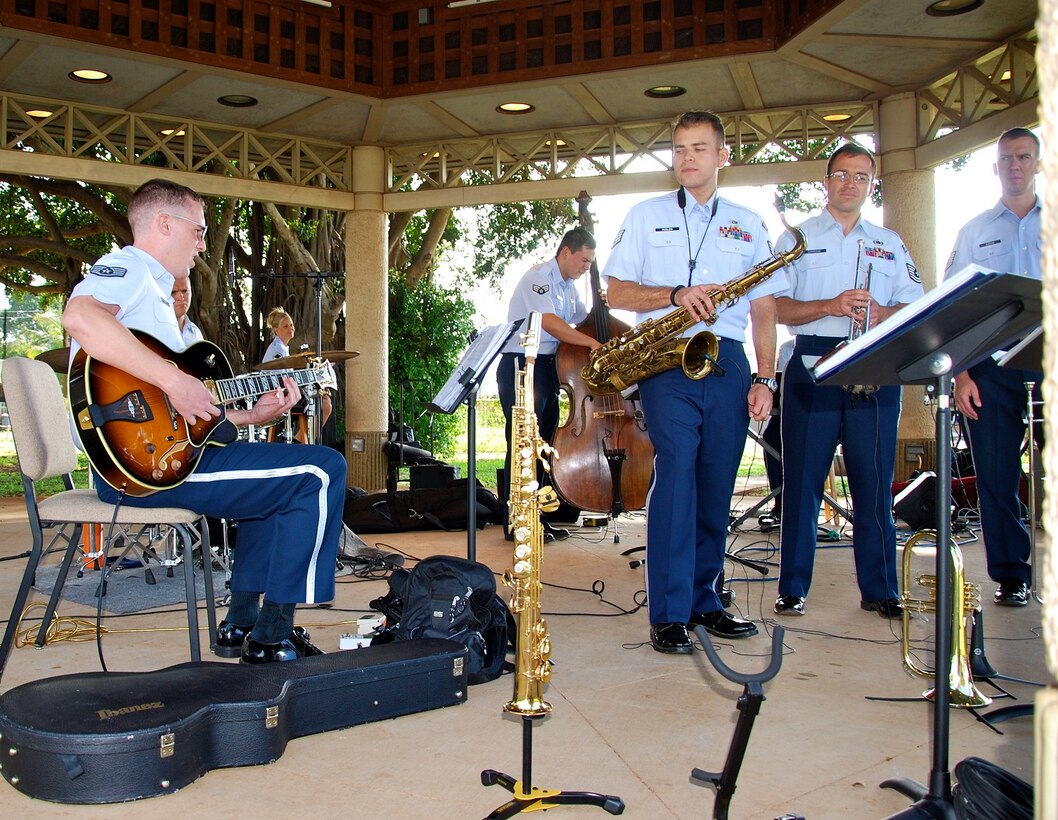 7 April 2013: SSgt Jesse Thompson plays a guitar solo as the horn section looks on. 