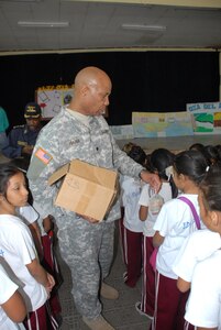Army Lt. Col. Michael Frazier, Director of Civil Affairs, hands out soaps to the students of Rosa de Valenzuela.Joint Task force-Bravo in cooperation with the Comayagua Police provided 750 bars of soap to the local school, Rosa de Valenzuela, as part of JTF-B continuous engagement and commitment to Honduras, April 5.