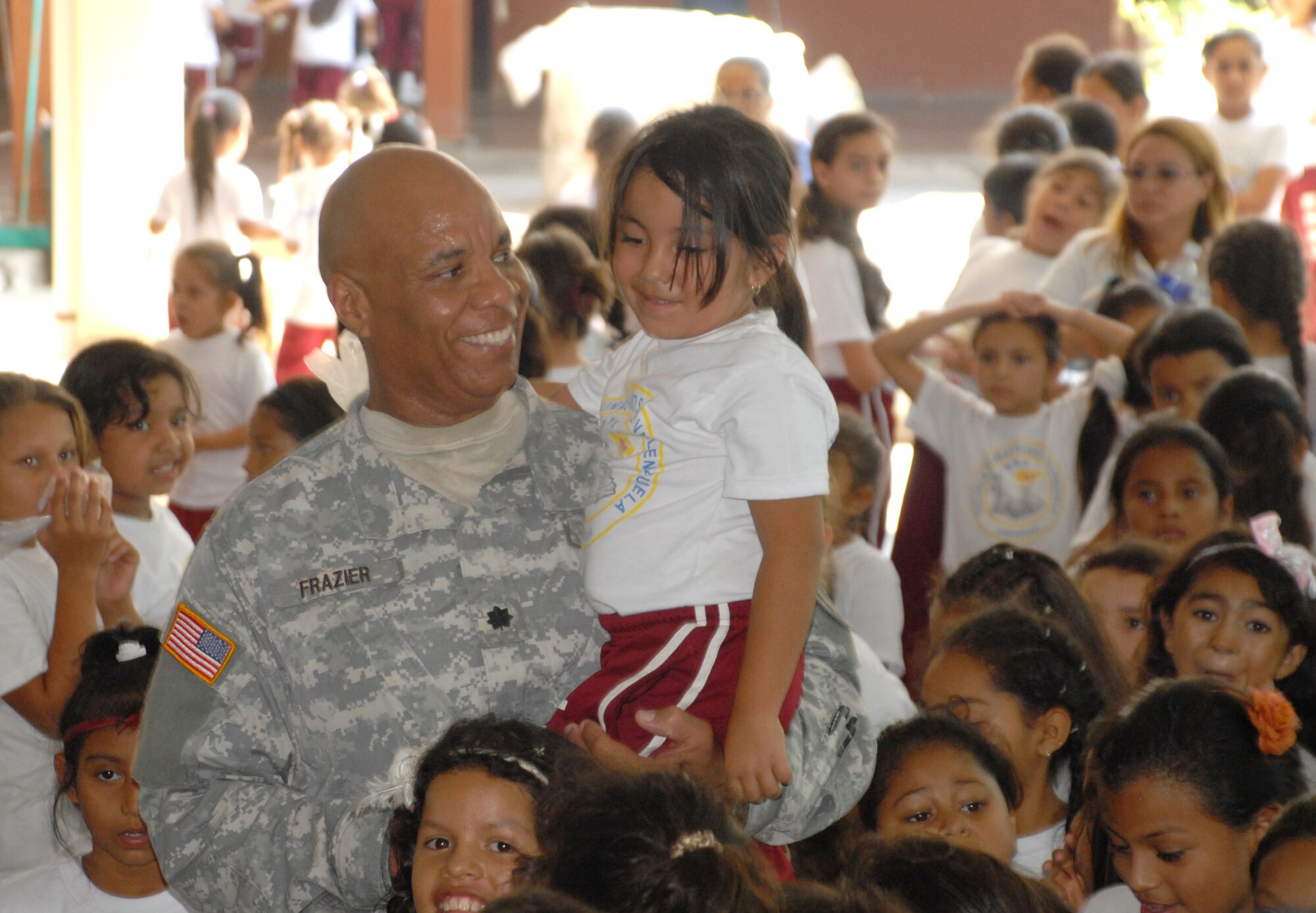 Army Lt. Col. Michael Frazier, Director of Civil Affairs, talks with one of the students at Rosa de Valenzeula. Joint Task force-Bravo in cooperation with the Comayagua Police provided 750 bars of soap to the local school, Rosa de Valenzuela, as part of JTF-B continuous engagement and commitment to Honduras, April 5.