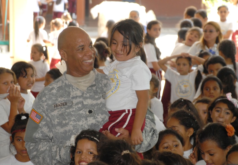 Army Lt. Col. Michael Frazier, Director of Civil Affairs, talks with one of the students at Rosa de Valenzeula. Joint Task force-Bravo in cooperation with the Comayagua Police provided 750 bars of soap to the local school, Rosa de Valenzuela, as part of JTF-B continuous engagement and commitment to Honduras, April 5.