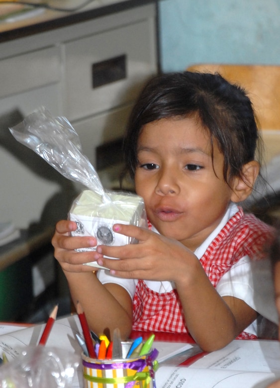 A student from Roas De Valenzuela looks over a pack of soap she received from members of the local police and Joint Task Force- Bravo. Joint Task Force-Bravo in cooperation with the Comayagua Police provided 750 bars of soap to the local school, Rosa de Valenzuela, as part of JTF-B continuous engagement and commitment to Honduras, April 5. (Civ. Photo by Ana Maria Fonseca)