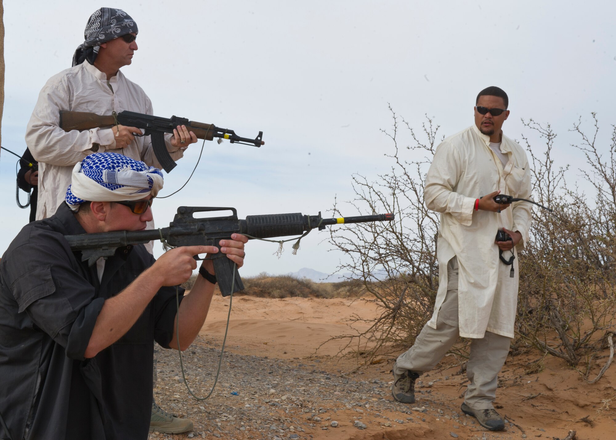 Command Chief Master Sgt. James Patrie and with two Rally Point Management contractors act as opposing forces during a simulated ground engagement as part of a Remotely Piloted Aircraft training scenario at White Sands Missile Range, N.M., April 5. Col. Andrew Croft, 49th Wing commander, and Chief Patrie were invited to participate in the Rally Point Management scenarios as the opposing force during an RPA training flight with students from Holloman Air Force Base, N.M. Rally Point Management trainers are experts on Joint Terminal Attack Controller (JTAC) and Close Air Support (CAS) procedures as well as ground warfighter equipment and software applications. The opportunity to be a part of the ground training scenarios helped 49th Wing leadership better understand RPA aircrews training experience here at Holloman AFB.  (U.S. Air Force photo by Senior Airman DeAndre Curtiss/Released) 