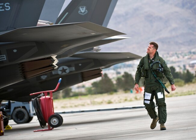 U.S. Air Force Lt. Col. Benjamin Bishop, 422nd Test and Evaluation Squadron director of operations, inspects the exhaust of an F-35A Lightning II before a training mission April 4, 2013, at Nellis Air Force Base, Nev. The F-35A is assigned to the 422nd TES and its modern engine delivers more than 60 percent more thrust than other aircraft of the same weight. (U.S. Air Force photo/Senior Airman Brett Clashman)