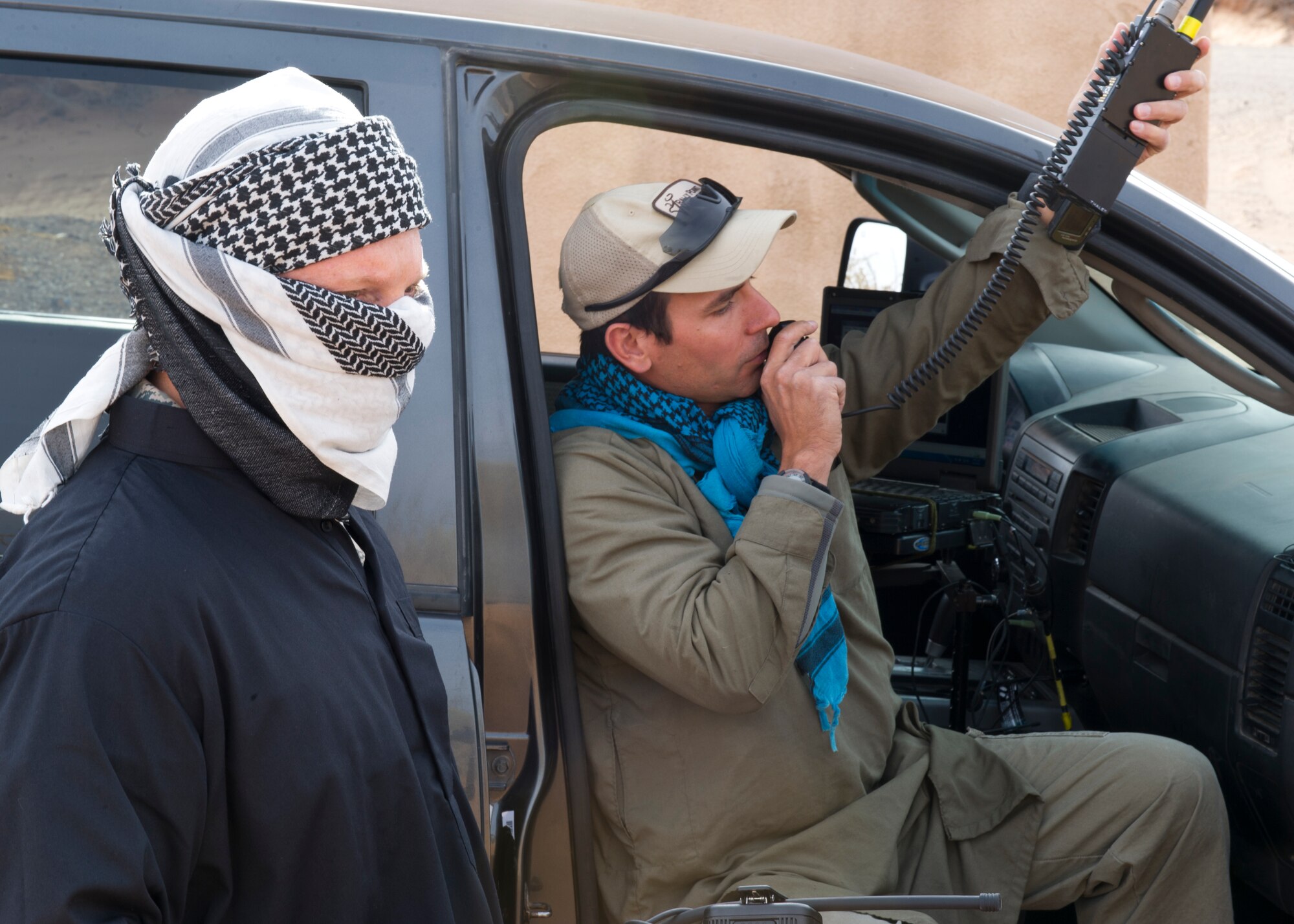 Colonel Andrew Croft, 49th Wing commander, dressed in black robe with white face cover, observes a Rally Point Management Remotely Piloted Aircraft training scenario at White Sands Missile Range, N.M., April 5. Colonel Croft, along with 49th Wing Command Chief Master Sgt. James Patrie were invited to participate in the Rally Point Management scenarios as the opposing force during an RPA training flight with students from Holloman Air Force Base, N.M. Rally Point Management trainers are experts on Joint Terminal Attack Controller (JTAC) and Close Air Support (CAS) procedures as well as ground warfighter equipment and software applications. The opportunity to be a part of the ground training scenarios helped 49th Wing leadership better understand RPA aircrews training experience here at Holloman AFB. (U.S. Air Force photo by Senior Airman DeAndre Curtiss/Released) 