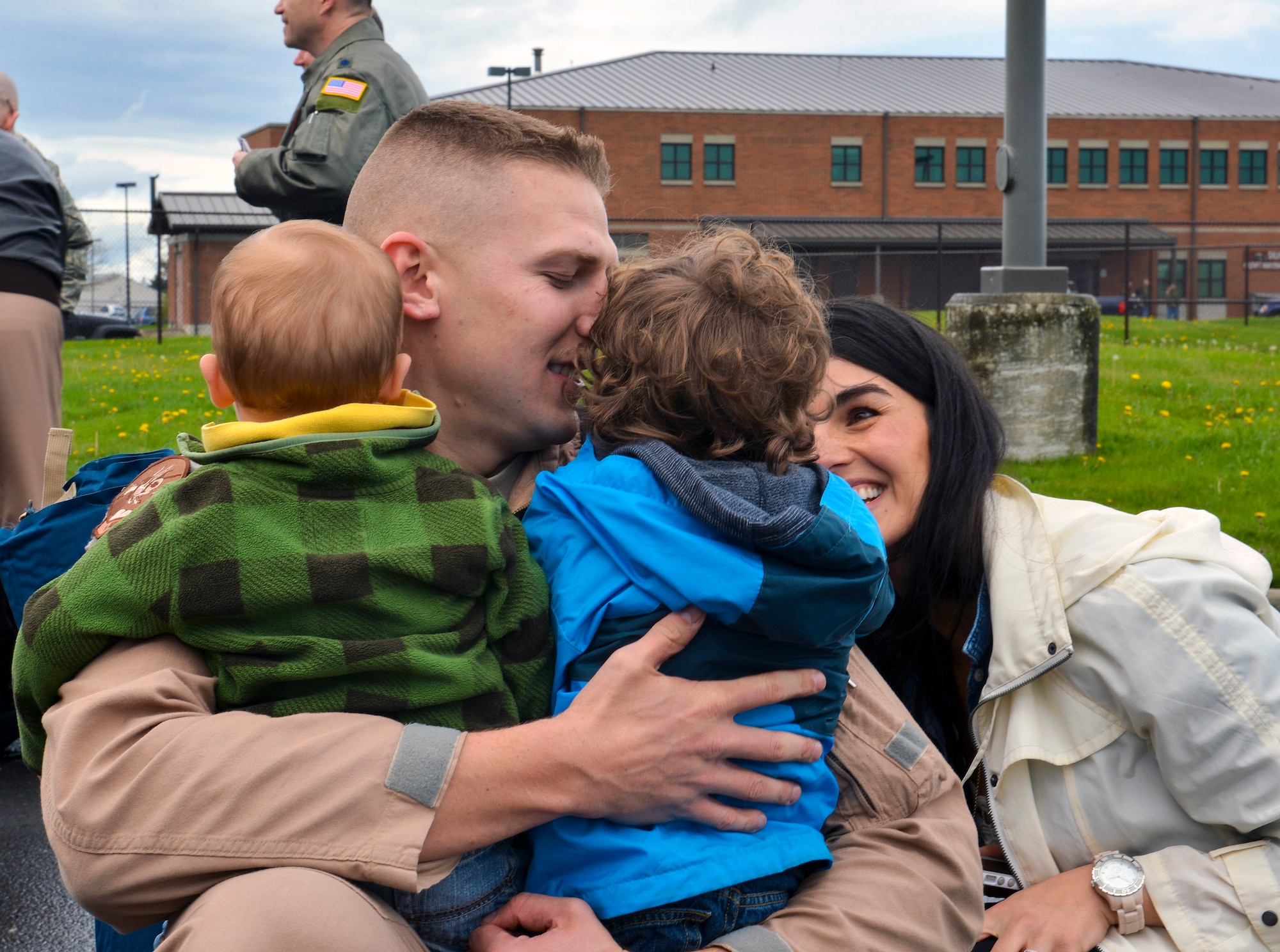 Capt. Chris Bohner, 8th Airlift Squadron pilot, embraces his two sons, Emmett and Vaughn, and his wife Maichal, upon returning home from a deployment, April 5, 2013, at Joint Base Lewis-McChord, Wash. Bohner returned home after being deployed for 60 days to Southwest Asia.  (U.S. Air Force photo/Airman 1st Class Jacob Jimenez)