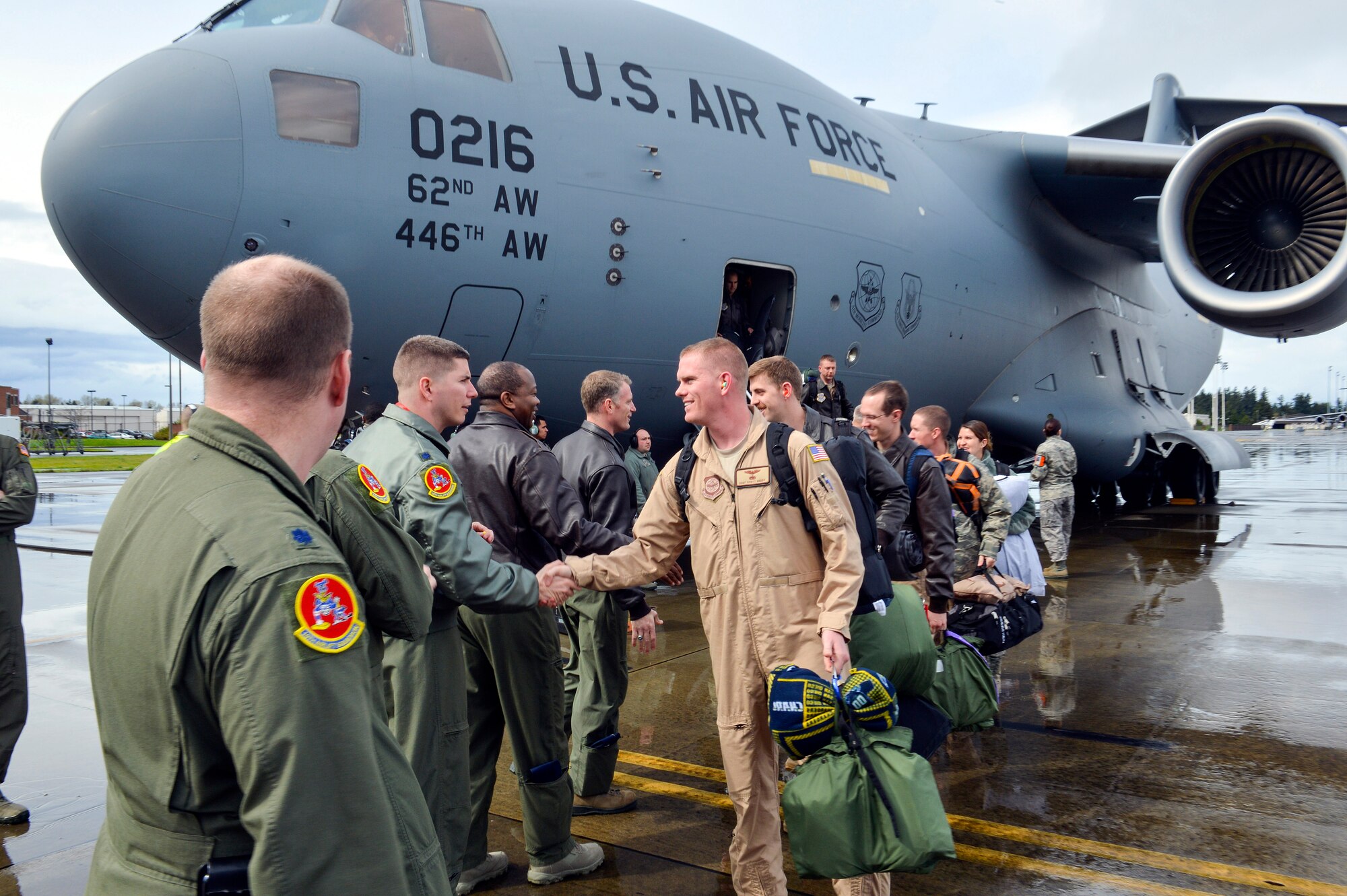 Members of the 8th Airlift Squadron are welcomed home as they return from a 60-day deployment to Southwest Asia in support of Operation Enduring Freedom, April 5, 2013, at Joint Base Lewis-McChord, Wash. The unit deployed as part of the 817th Expeditionary Airlift Squadron to provide global strategic airlift, airdrop, aeromedical evacuation and humanitarian relief. (U.S. Air Force photo/Airman 1st Class Jacob Jimenez)