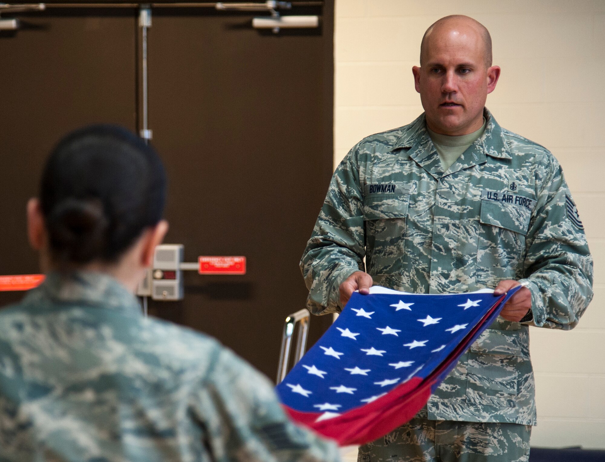 Tech Sgt. Kenneth Bowman folds an American flag with a fellow honor guard member during practice at Laughlin Air Force Base, Texas, March 12, 2013. Bowman is the NCO in charge of Laughlin’s Honor Guard and is assigned to the 47th Force Support Squadron. He was selected as the 2012 Best Honor Guard Program Manager for Air Education and Training Command’s Flying Training Wings. (U.S. Air Force photo/Senior Airman Nathan Maysonet)