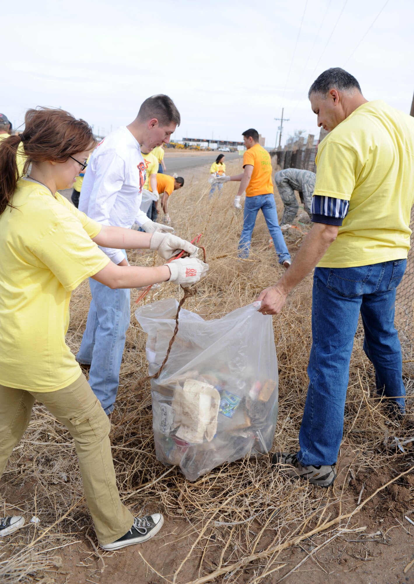 U.S. Air Force Airman 1st Class Christina Burklow, 27th Special Operations Communication’s Squadron, cyber security technician,   picks up litter at the annual Great American Clean Up in Clovis N.M., April 6, 2013. More than 150 volunteers from Cannon Air Force Base joined with volunteers from the community to clean up the streets of Clovis. (U.S. Air Force photo/Airman 1st Class Ericka Engblom)