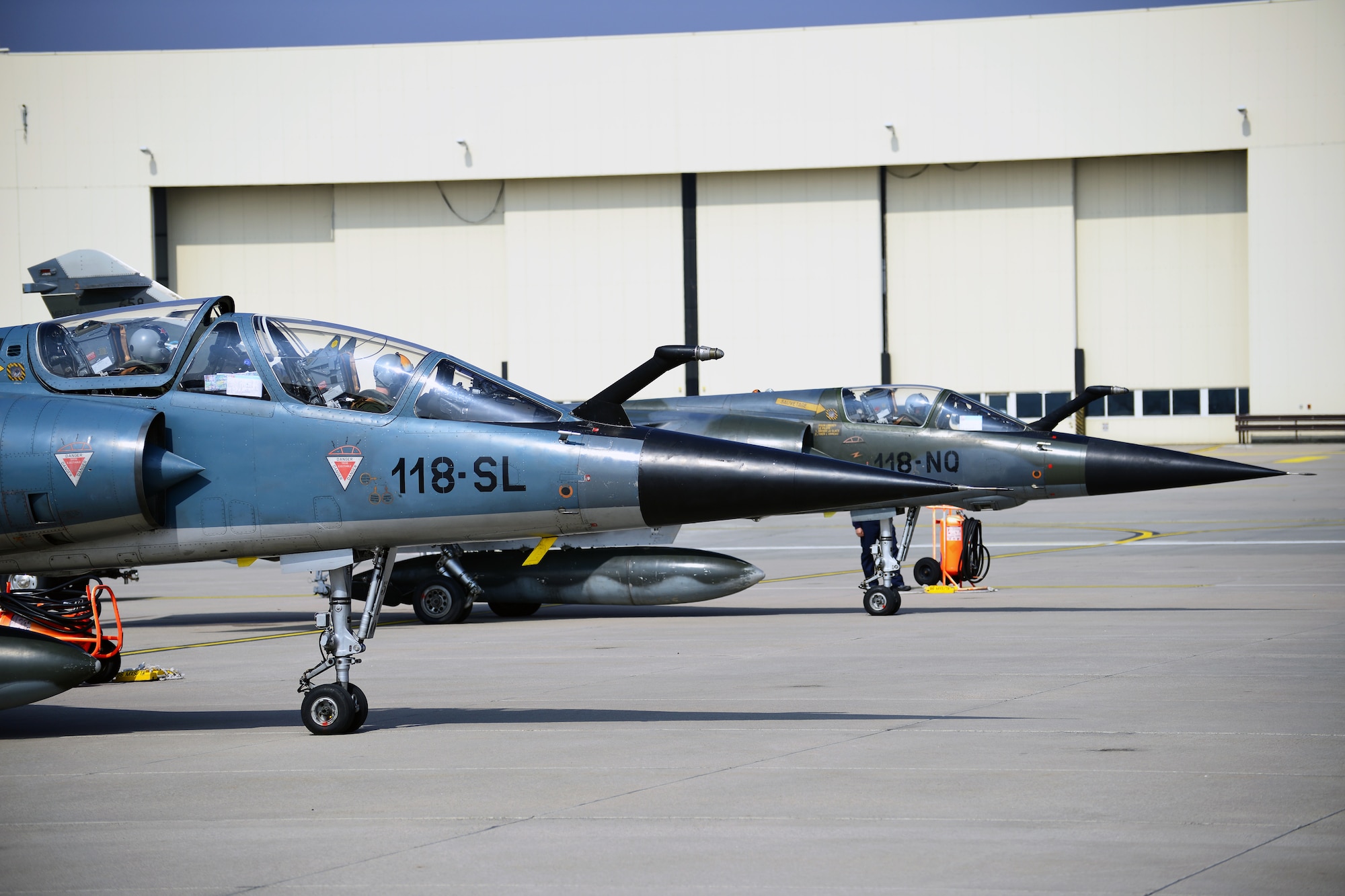 Two French F-1 Mirages prepare to taxi and take off from Ramstein Air Base, Germany, April 4, 2013. The three French pilots and two Mirages, were here to conduct a familiarization flight and attend a planning and preparation conference at NATO's Headquarters, Allied Air Command, related to the French air force four-month Baltic Air Policing deployment starting in May. (U.S. Air Force photo/Tech. Sgt. Chad Thompson)