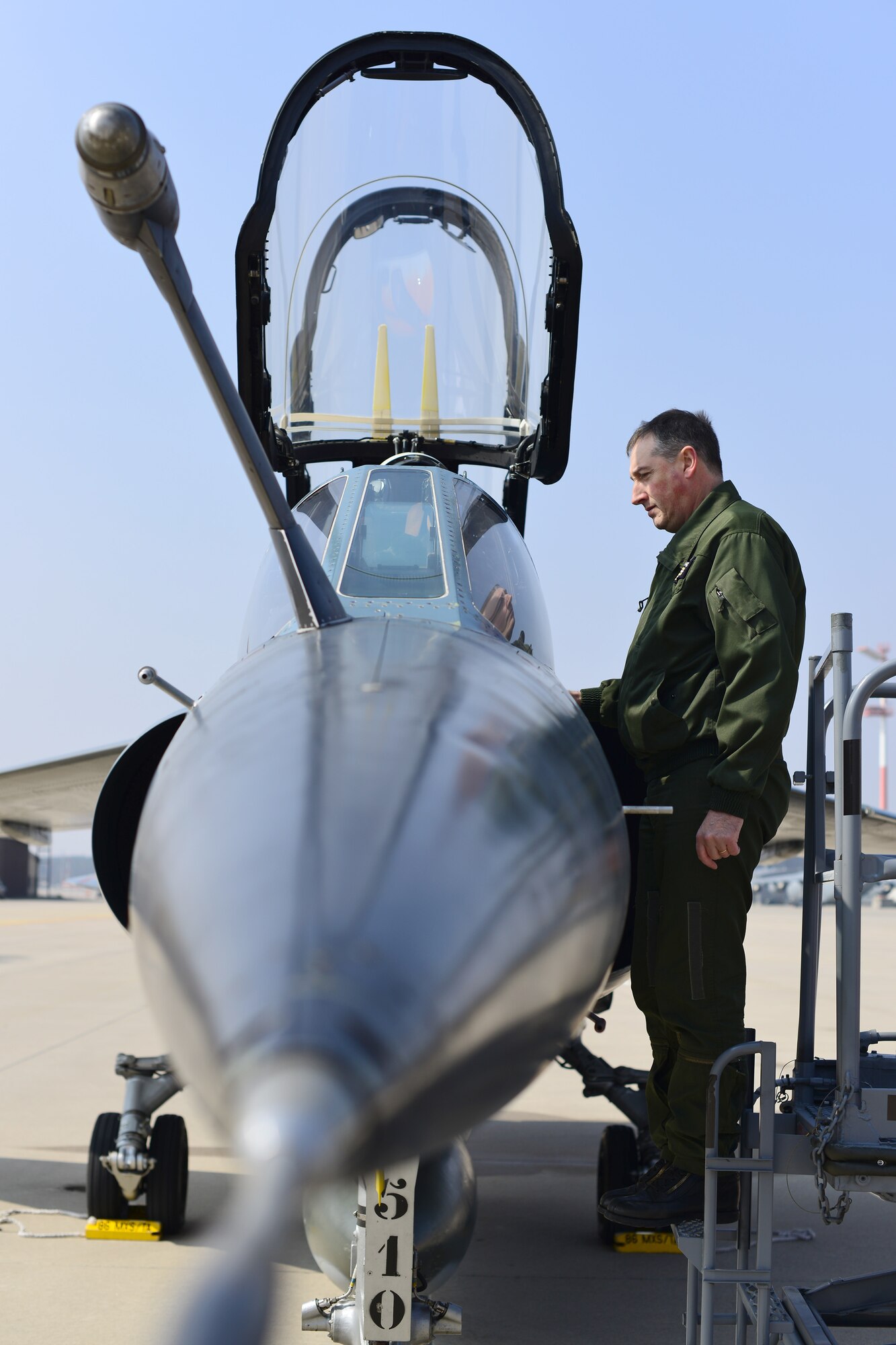 Lt. Col. Frederic Vieil, an operations officer with NATO's Headquarters, Allied Air Command, runs through F-1 Mirage pre-flight checks with a French pilot before takeoff from Ramstein Air Base, Germany, April 4, 2013. The three French pilots and two Mirages, were here to conduct a familiarization flight and attend a planning and preparation conference at NATO's Headquarters, Allied Air Command, related to the French air force four-month Baltic Air Policing deployment starting in May. (U.S. Air Force photo/Tech. Sgt. Chad Thompson)