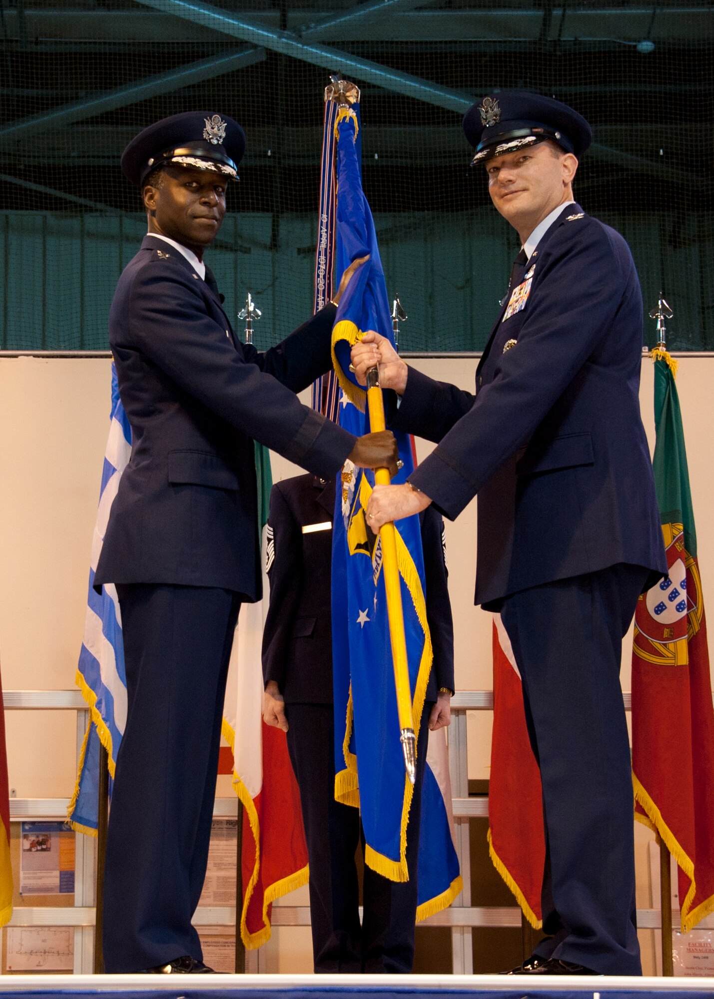 Gen. Edward A. Rice (left) passes the unit colors to Col. Lance R. Bunch during the 80th Flying Training Wing's change of command ceremony March 28 at Sheppard Air Force Base.  Bunch comes to Sheppard from the Pentagon.  (U.S. Air Force photo/Danny Webb)