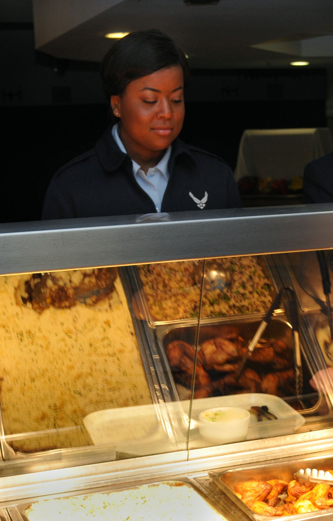 Airman 1st Class Sydnie Tate, 100th Force Support Squadron cook, waits in line for lunch before watching “Schindler's List” April 8, 2013, at the Gateway Dining Facility on RAF Mildenhall, England. Between April 8 to 12 the Holocaust Remembrance Committee is showing “Schindler's List” and “The Reader” during the lunch hour at the Gateway Dining Facility and the Flightline Kitchen. (U.S. Air Force photo by Airman 1st Class Kelsey Waters/Released) 