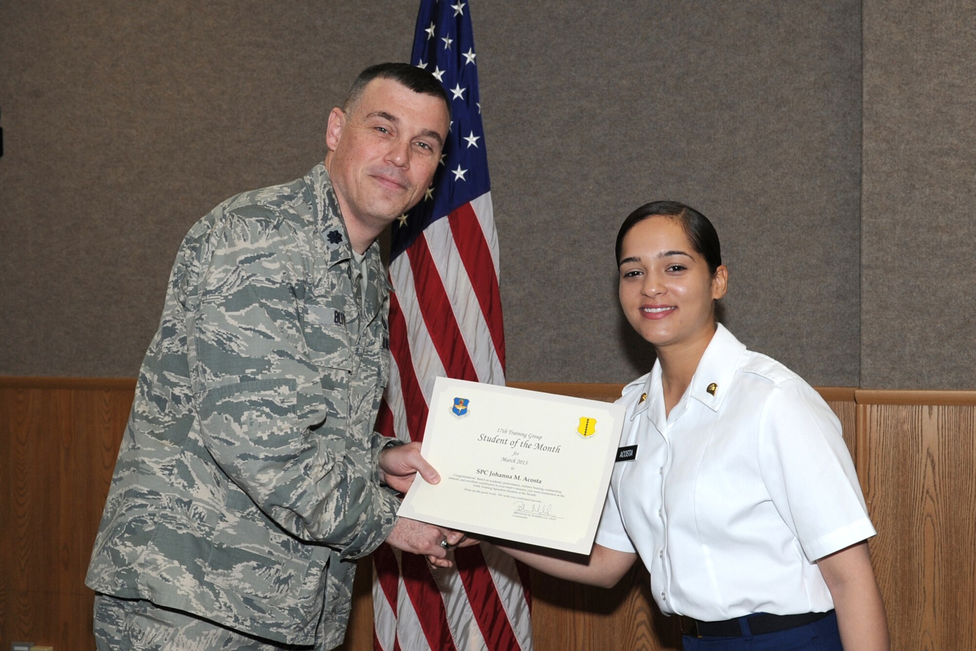 GOODFELLOW AIR FORCE BASE, Texas-- Lt. Col. Edward Blitt, 17th Training Group Deputy Commander, presents Army Spc. Johanna Acosta with the 316th Training Squadron Student of the Month award for March, April 5. (U.S. Air Force photo/Staff Sgt. Laura R. McFarlane)