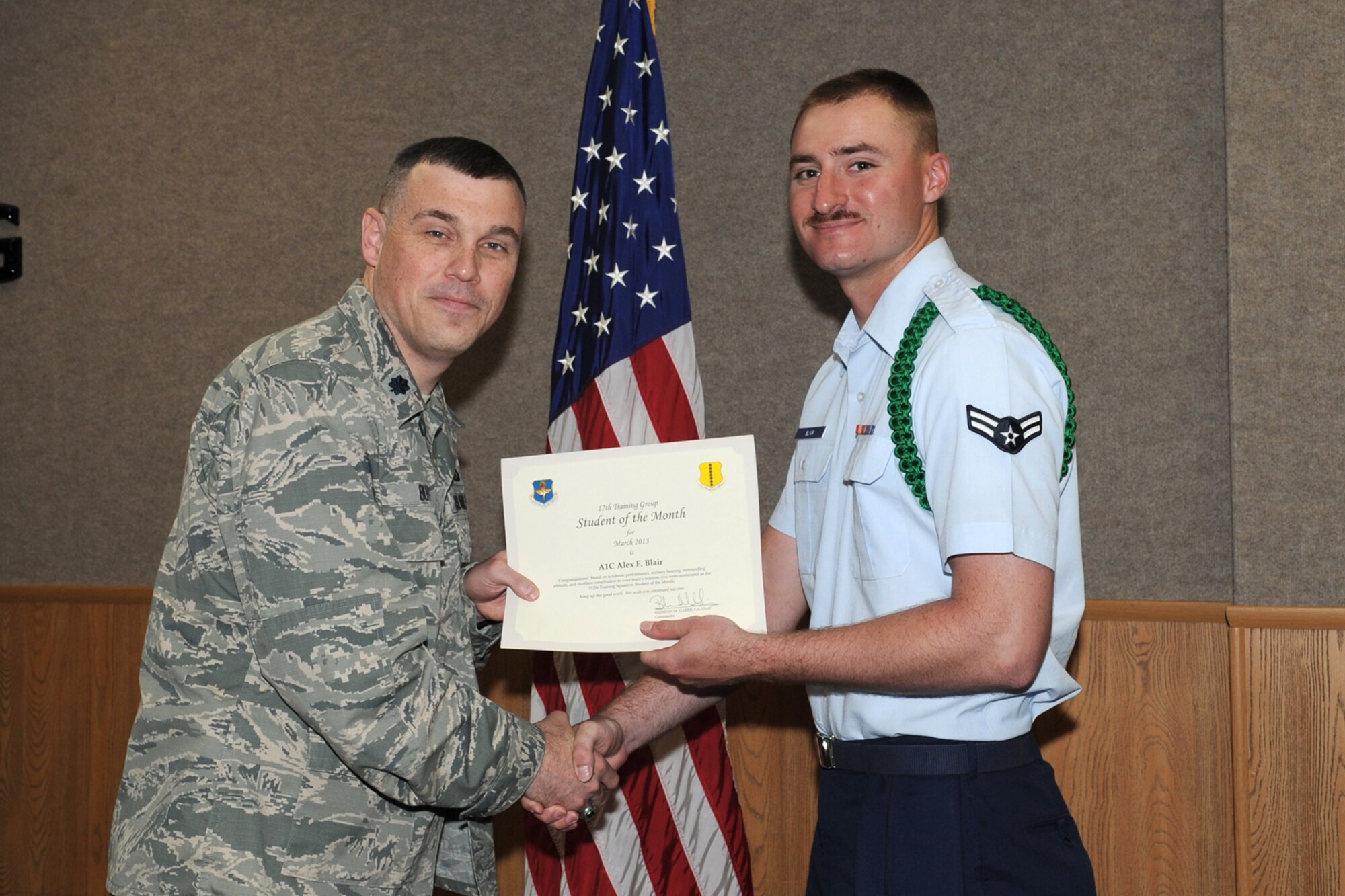GOODFELLOW AIR FORCE BASE, Texas-- Lt. Col. Edward Blitt, 17th Training Group Deputy Commander, presents Airman 1st Class Alex Blair with the 312th Training Squadron Student of the Month award for March, April 5. (U.S. Air Force photo/Staff Sgt. Laura R. McFarlane)