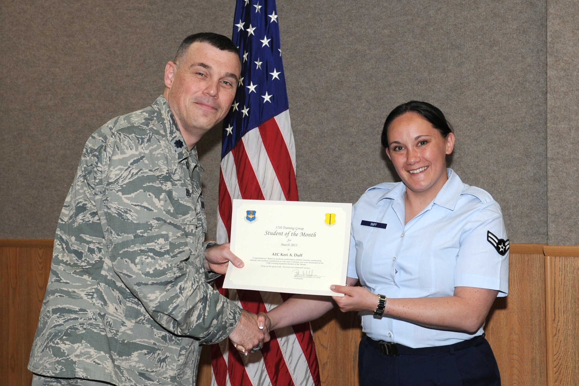 GOODFELLOW AIR FORCE BASE, Texas-- Lt. Col. Edward Blitt, 17th Training Group Deputy Commander, presents Airman 1st Class Keri Duff with the 315th Training Squadron Enlisted Student of the Month award for March, April 5. (U.S. Air Force photo/Staff Sgt. Laura R. McFarlane)