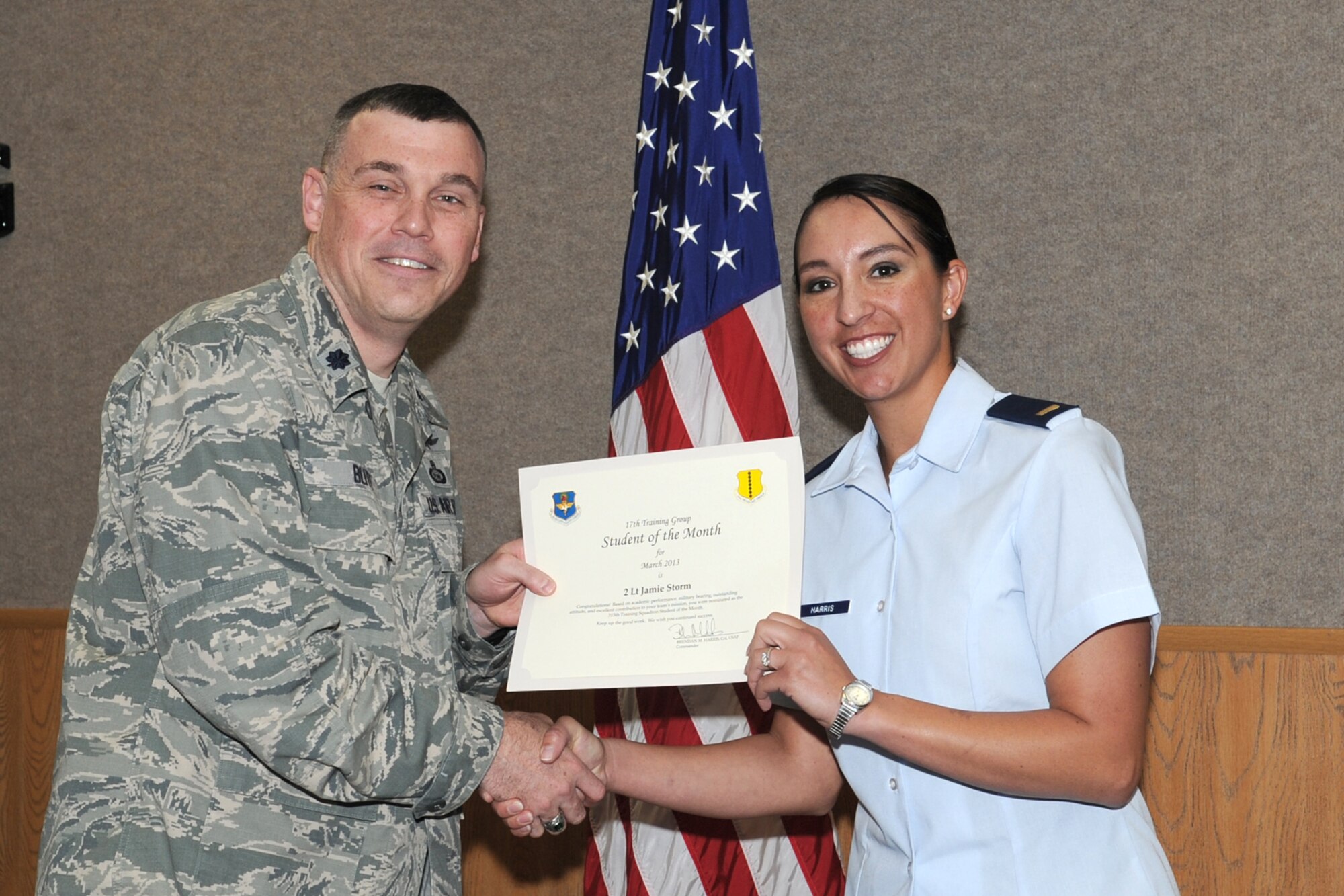 GOODFELLOW AIR FORCE BASE, Texas-- Lt. Col. Edward Blitt, 17th Training Group Deputy Commander, presents 2nd Lt. Jamie Harris with the 315th Training Squadron Officer Student of the Month award for March, April 5. (U.S. Air Force photo/Staff Sgt. Laura R. McFarlane)
