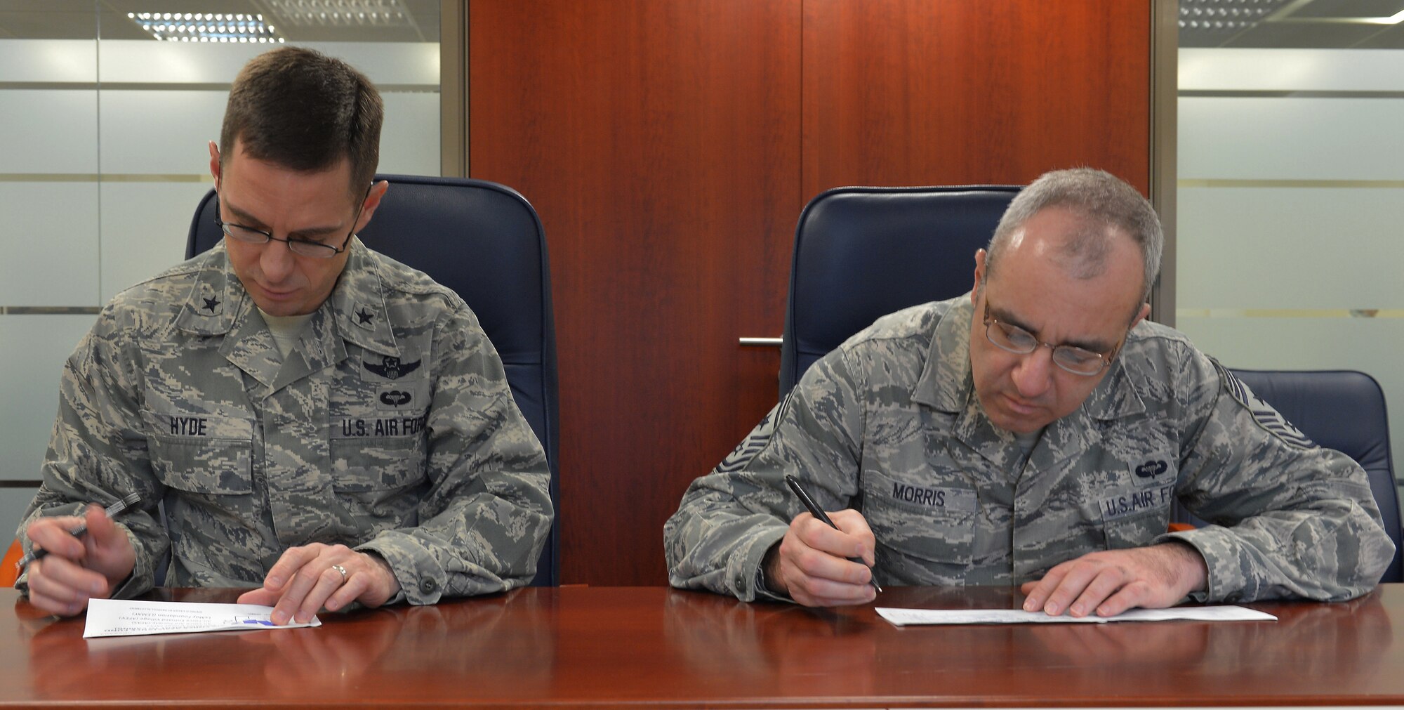 Brig. Gen. C. K. Hyde, 86th Airlift Wing commander, and Chief Master Sgt. James Morris, 86th AW command chief, fill out an Air Force Assistance Fund form on Ramstein Air Base, Germany, April 3, 2013. The AFAF was established to provide assistance through donations to organizations charged with helping Airmen and their families. (U.S. Air Force photo/Airman 1st Class Holly Cook) 