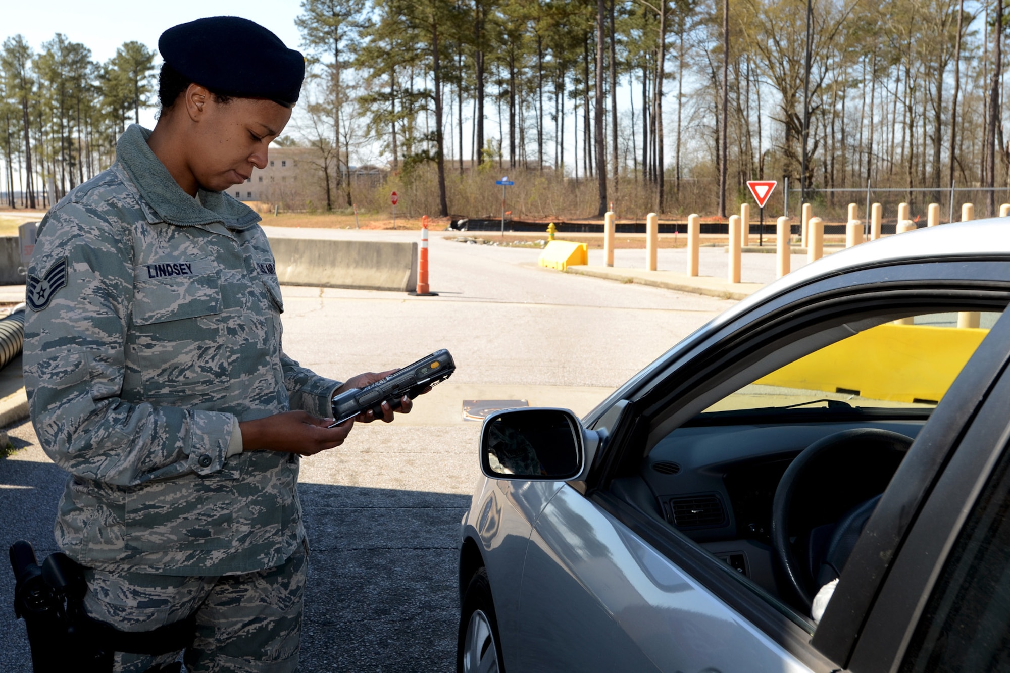 Staff Sgt. Bianca Lindsey, security forces personnel with the 169th Security Forces Squadron at McEntire Joint National Guard Base, S.C., checks ID cards at the main gate entrance using the Defense Biometric Identification System scanner, March 28, 2013.
(National Guard photo by Tech. Sgt. Caycee Watson/Released)