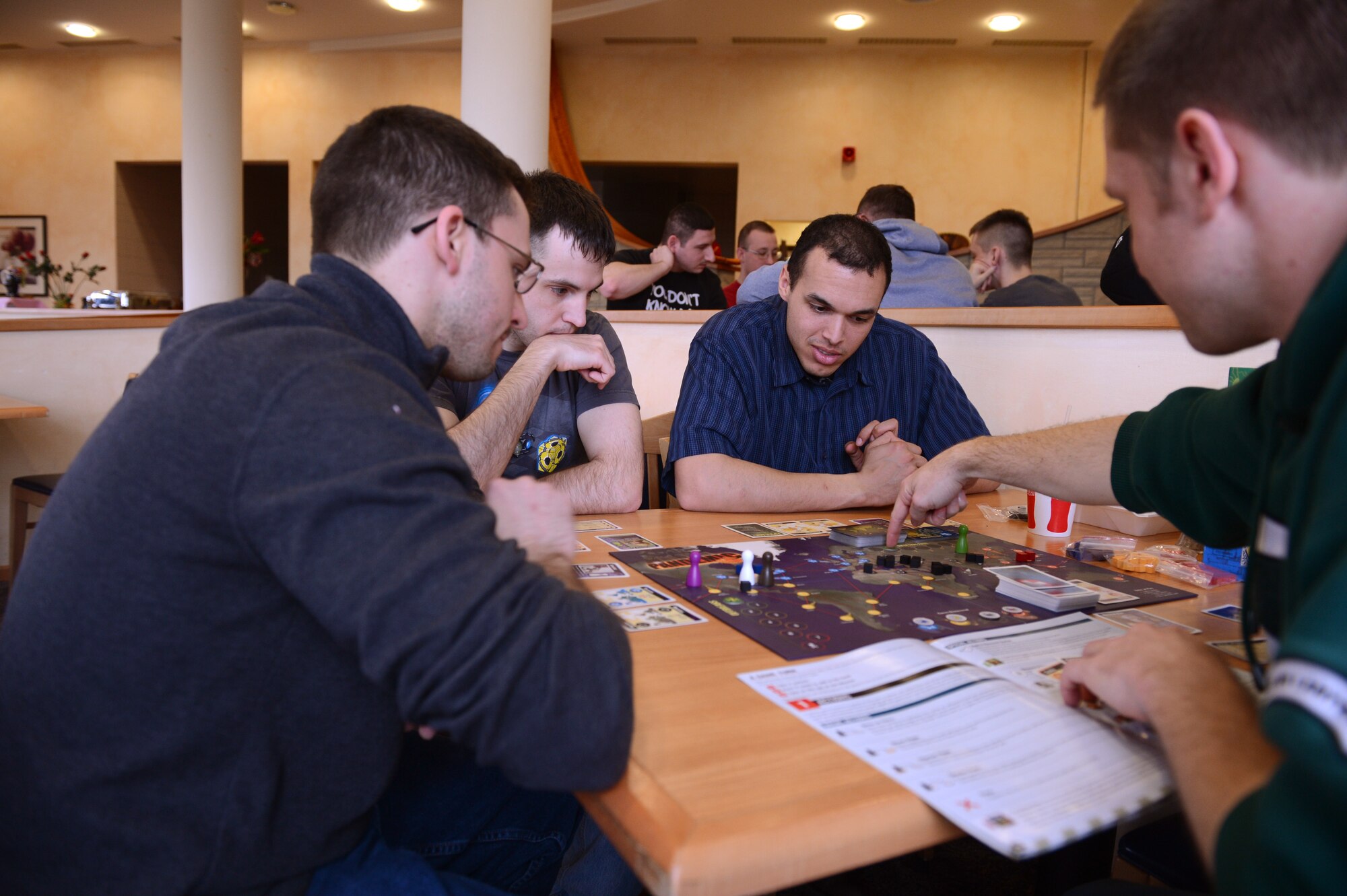 SPANGDAHLEM AIR BASE, Germany – U.S. Air Force Airmen play Pandemic together at Club Eifel April 6, 2013. This table-top gaming night is hosted by the 52nd Force Support Squadron for new and experienced gaming enthusiasts. (U.S. Air Force photo by Airman 1st Class Kyle Gese/Released)