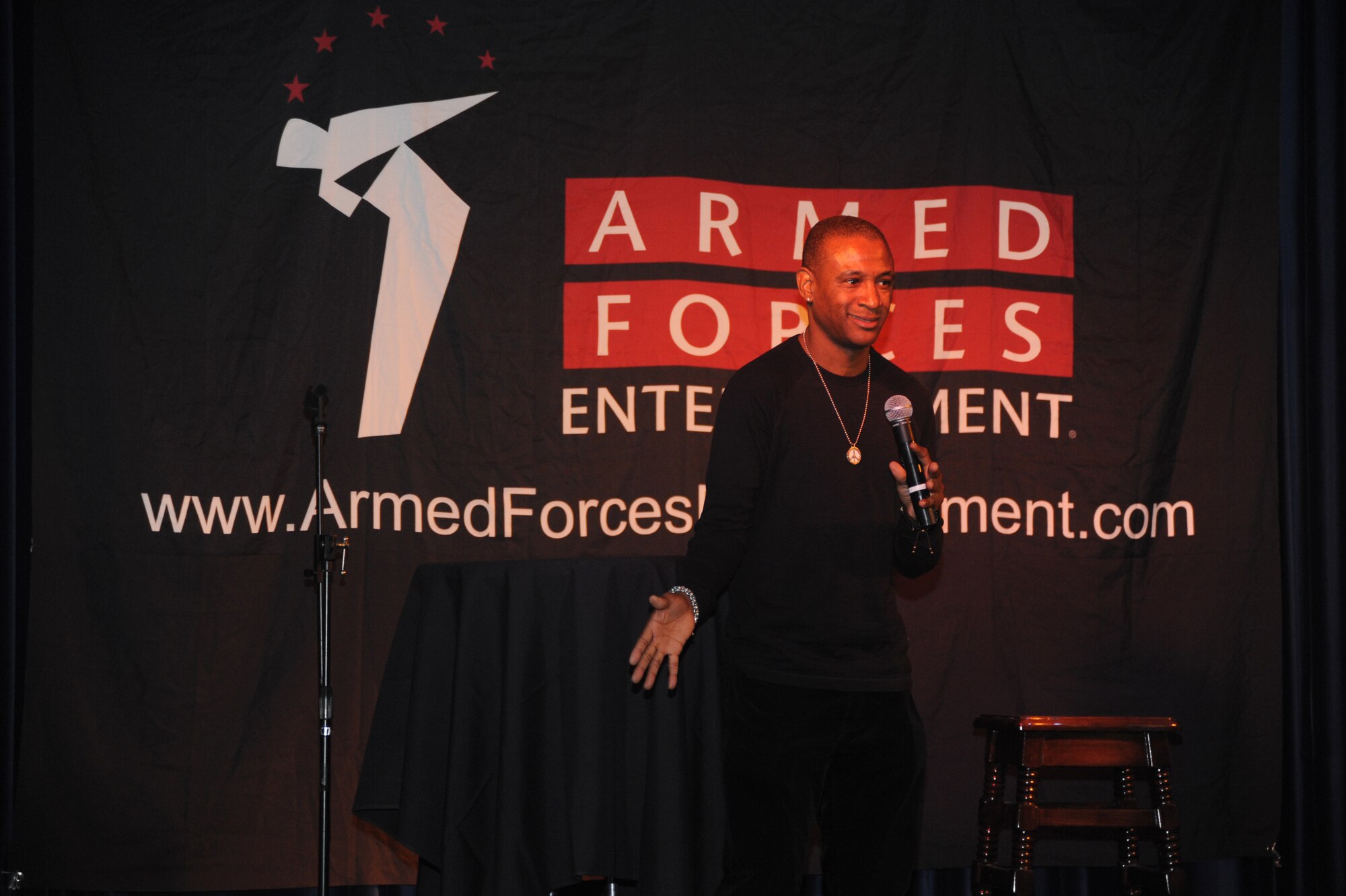 Comedian Tommy Davidson tells jokes to an audience of service members and families during a comedy show at the Club Complex April 5, 2013 at Incirlik Air Base, Turkey. Davidson and fellow comedian Alexe Liss toured the base signing autographs and performed a comedy show as part of an Armed Forces Entertainment tour. (U.S. Air Force photo by Staff Sgt. Eric Summers Jr./Released)