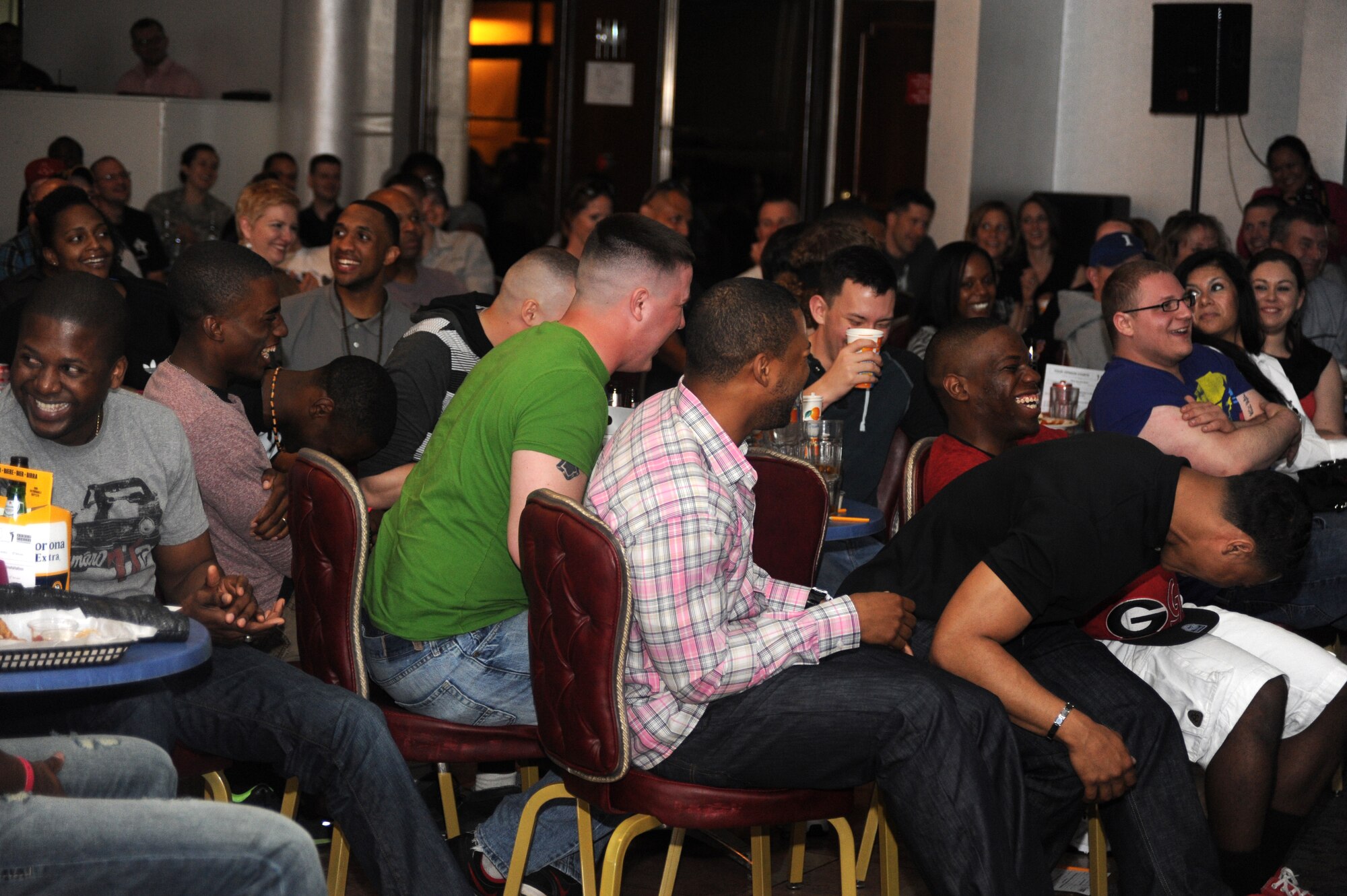 Members of Incirlik Air Base laugh as comedian Tommy Davidson tells jokes during a comedy show at the Club Complex April 8, 2013, at Incirlik Air Base, Turkey. Davidson and fellow comedian Alexe Liss performed for the base community as part of an Armed Forces Entertainment tour. (U.S. Air Force photo by Staff Sgt. Eric Summers Jr./Released)