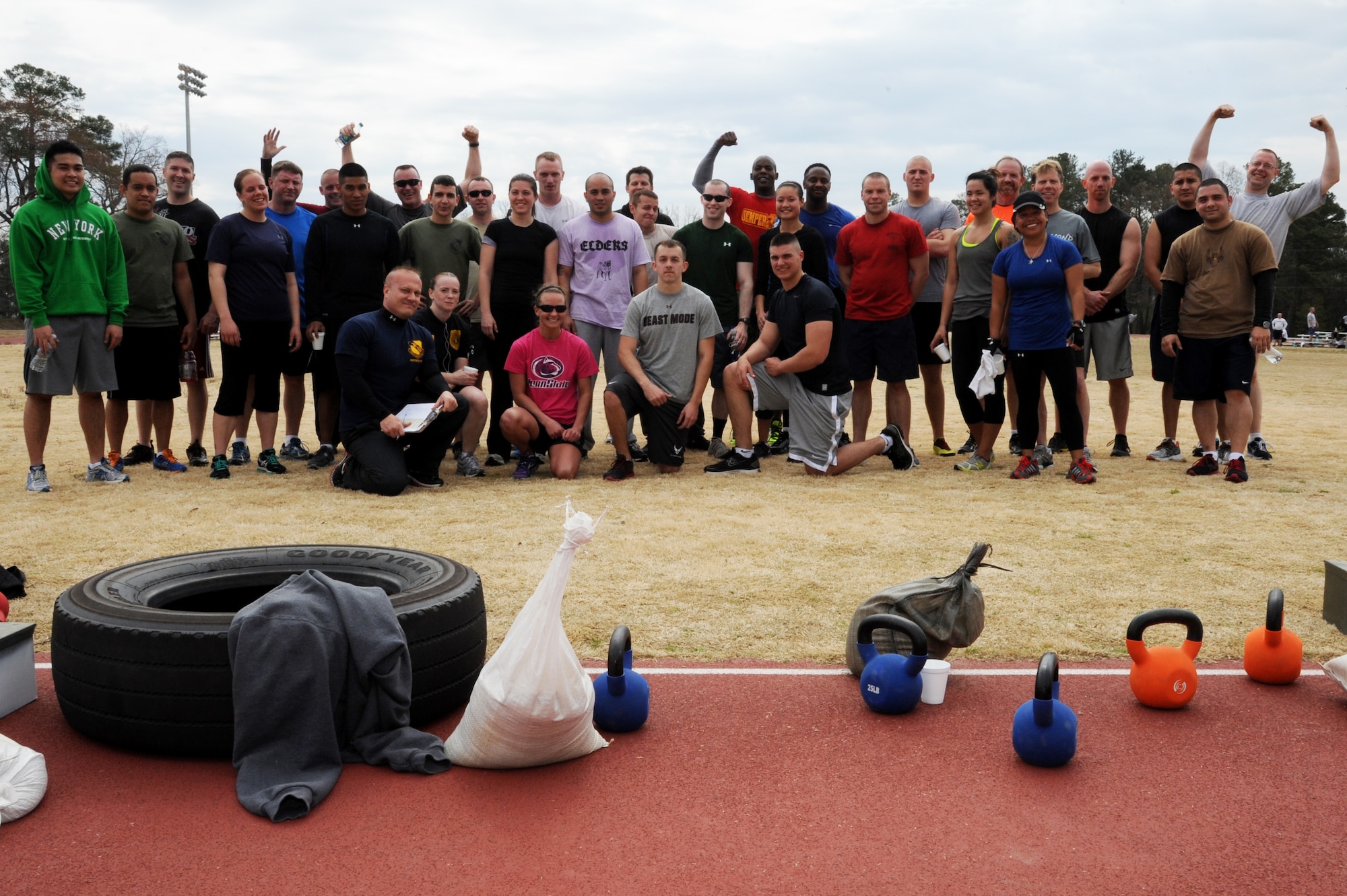 Competitors pose for a photo after completing the Combat Fitness Challenge at the fitness center track on Seymour Johnson Air Force Base, N.C., March 30, 2013.  The competition was designed to promote overall fitness by challenging participants to perform cardio, strength and endurance exercises. (U.S. Air Force photo by Airman 1st Class Brittain Crolley/Released)