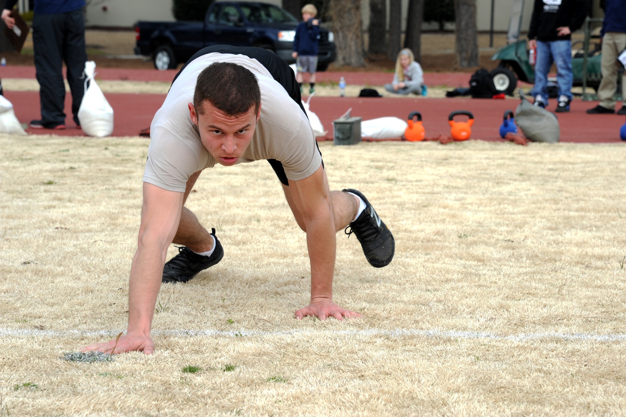U.S. Air Force Airman 1st Class Jordan Melendez, 4th Aircraft Maintenance Squadron avionics technician, performs a bear crawl during a 100-meter dash at the fitness center track on Seymour Johnson Air Force Base, N.C., March 30, 2013.  Melendez was the top performer at the competition, completing the course with a time of 39 minutes, 22 seconds. (U.S. Air Force photo by Airman 1st Class Brittain Crolley/Released)