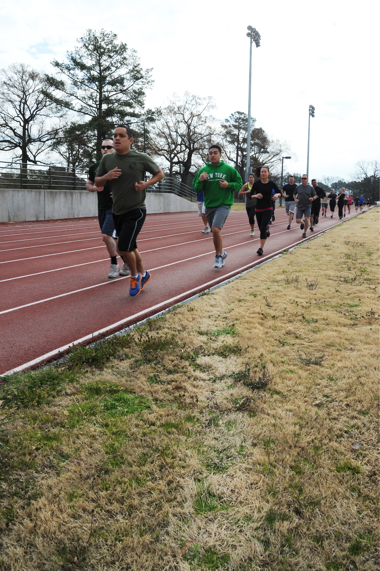 Combat Fitness Challenge participants begin the competition by running a lap on the track at the fitness center on Seymour Johnson Air Force Base, N.C., March 30, 2013.  The competitors ran seven laps on the quarter-mile track and one lap on the two-mile track in addition to completing six 100-meter dashes and four exercise stations. (U.S. Air Force photo by Airman 1st Class Brittain Crolley/Released)