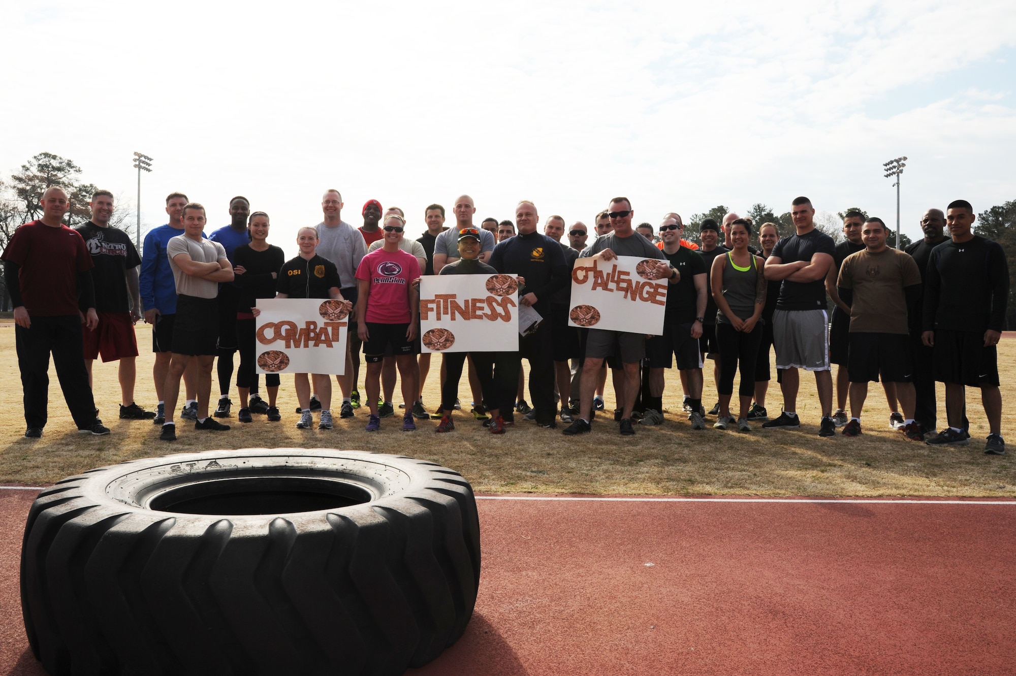 Participants gather together for a group photo before competing in the Combat Fitness Challenge at the fitness center track on Seymour Johnson Air Force Base, N.C., March 30, 2013.  The competitors completed numerous challenges that tested their cardio, strength and physical endurance. (U.S. Air Force photo by Airman 1st Class Brittain Crolley/Released)