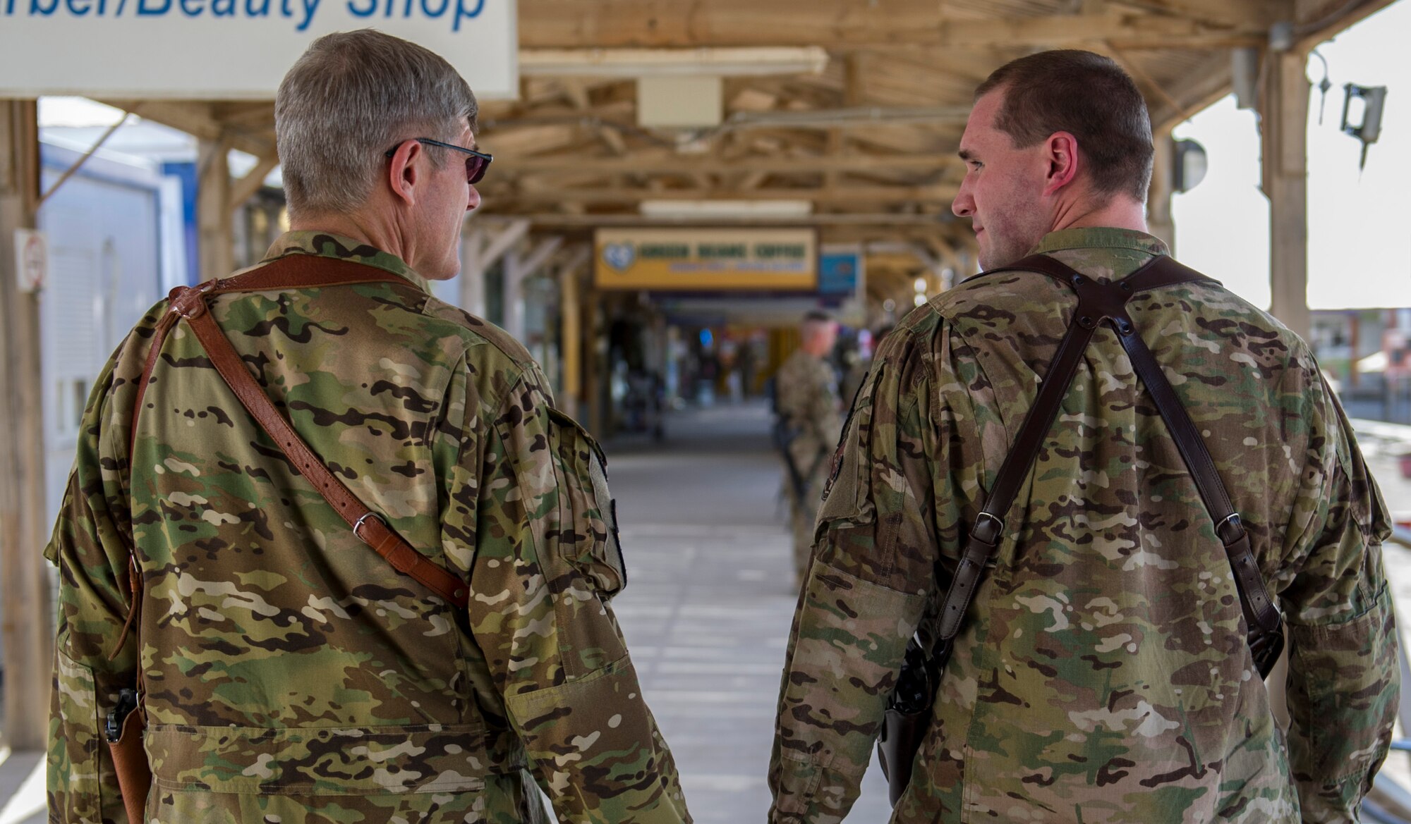 Capt. Justin, left, 361st Expeditionary Reconnaissance Squadron chief of scheduling, and Lt. Col. Robert, right, 62nd ERS remotely piloted aircraft pilot, walk together, March 4, 2013, on Kandahar Airfield, Afghanistan. Robert is deployed at the same time to the same location as his son, Justin. (U.S. Air Force photo by Staff Sgt. Marleah Miller)