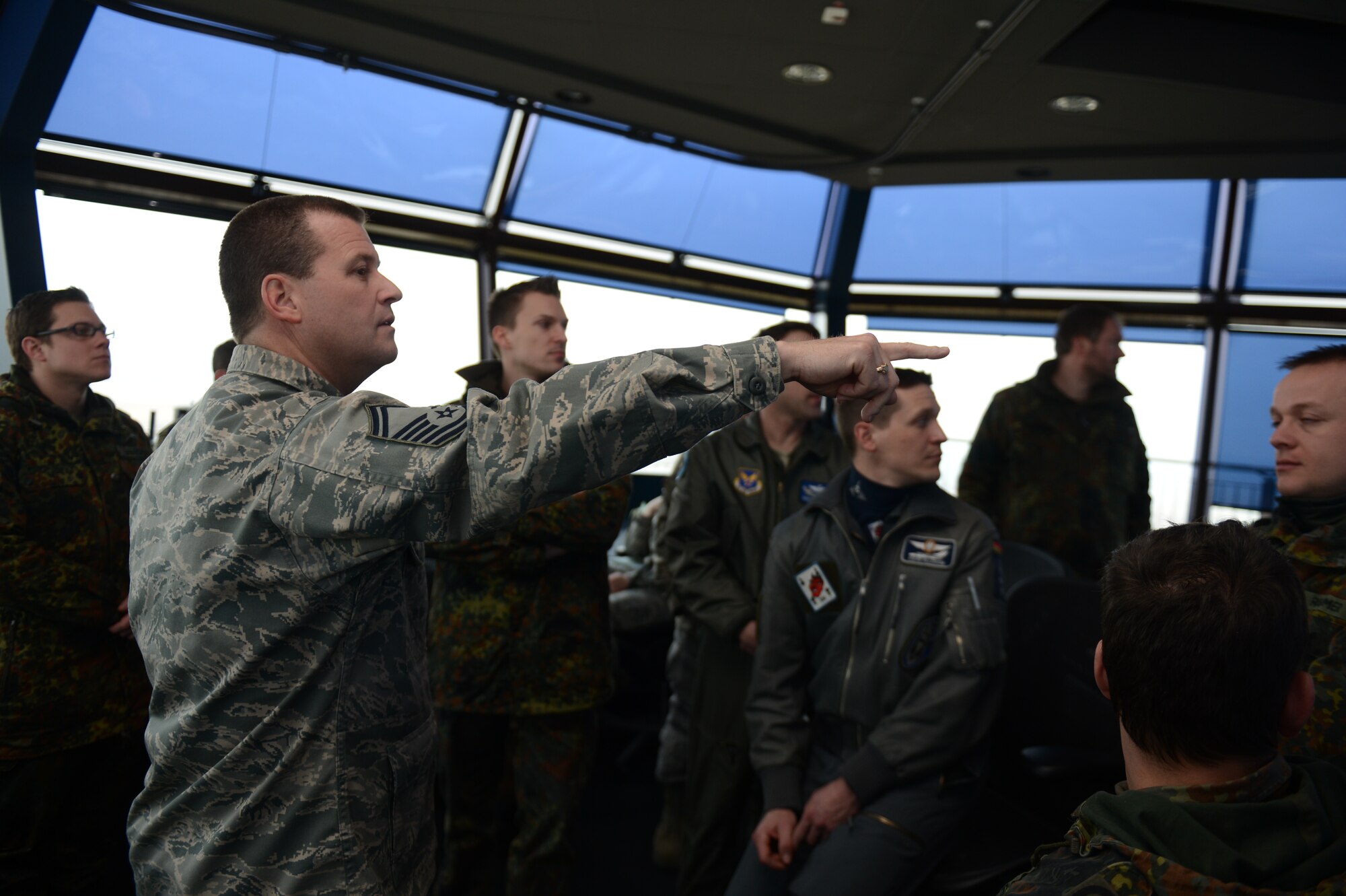 SPANGDAHLEM AIR BASE, Germany – U.S. Air Force Senior Master Sgt. Allan Turk, 52nd Operations Support Squadron tower chief controller from Zanesville, Ohio, showcases air traffic control tower operations to German Bundeswehr and Deutsche Flug Sicherung members as part of a Spangdahlem Air Base tour April 3, 2013. German military from five different bases attended the tour of 52nd Fighter Wing facilities to deepen cooperation with the wing and further partnerships with NATO allies. (U.S. Air Force photo by Airman 1st Class Gustavo Castillo/Released)