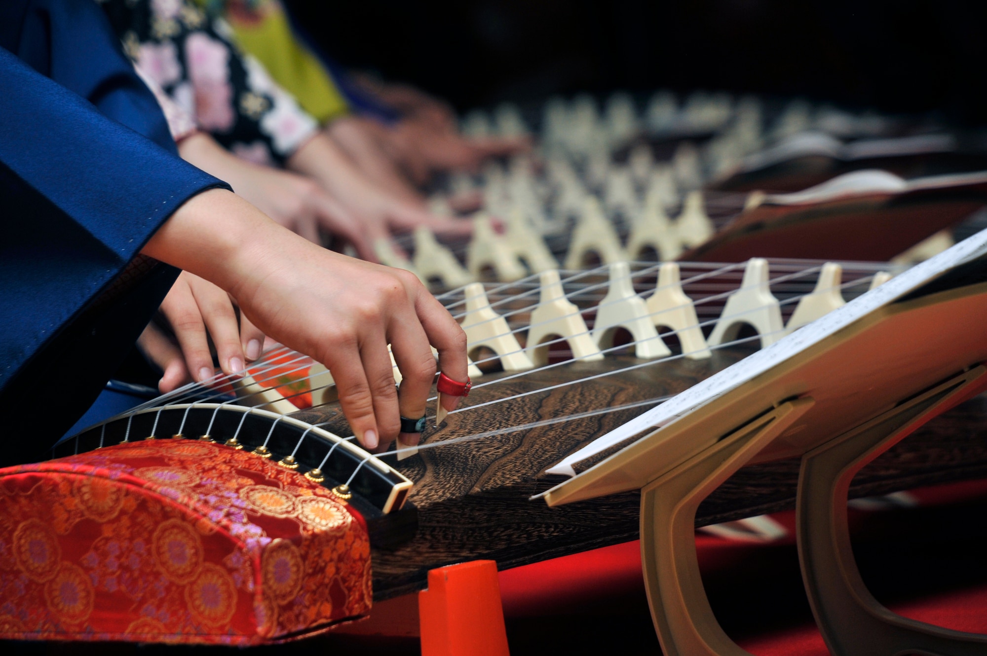 Musicians from the Yanada Shinko perform Koto music during the 26th Annual Japan Day at Misawa Air Base, Japan, April 6, 2013. The Koto is the national instrument of Japan that has 13 strings, which are strung over 13 movable bridges along the width of the instrument.  (U.S. Air Force photo by Airman 1st Class Zachary Kee)