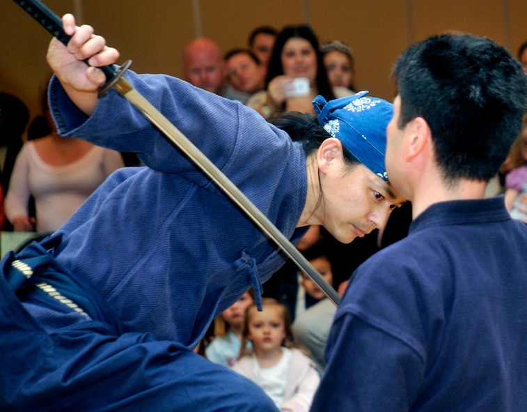 Members of the Hirosaki Badara Club give a sword fighting show during the 26th Annual Japan Day at Misawa Air Base, Japan, April 6, 2013. Japan Day represents a unique opportunity for Misawa residents to experience Japanese culture. More than 40 cultural displays, hands-on demonstrations, live music and theatrical demonstrations were exhibited throughout the day. (U.S. Air Force photo by Airman 1st Class Zachary Kee)