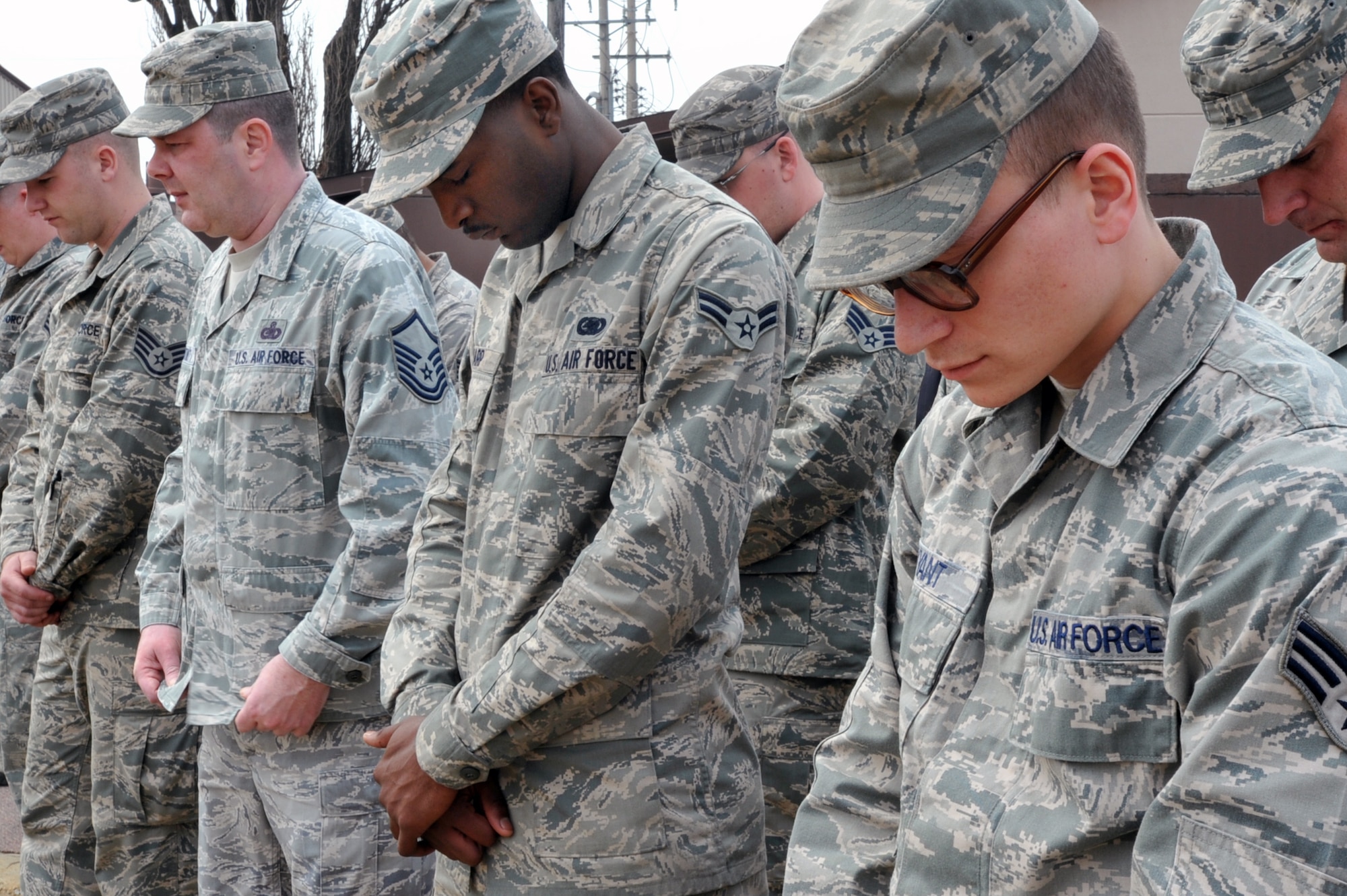 Airmen from the 51st Logistics Readiness Squadron bow their heads for a minute of silence in a memorial ceremony for the people who lost their lives in a fuel tank fire in 1986 on April 5, 2013. In total, 16 were killed and 11 were injured. Of the 16, 15 were Korean nationals and one was U.S.  Air Force Sgt. Enrique Lozano, 23, assigned to the 51st Supply Squadron. (U.S. Air Force photo/Senior Airman Alexis Siekert)