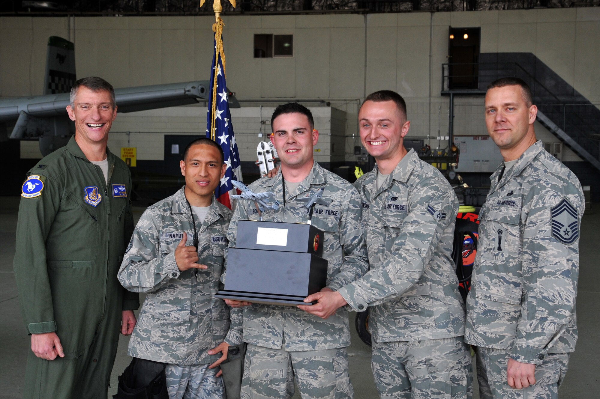 Col. Patrick McKenzie, 51st Fighter Wing commander, presents the 25th Aircraft Maintenance Unit load crew team with the Load Crew of the Quarter trophy at Osan Air Base, Republic of Korea, April 5, 2013.  The 25th AMU weapons load crew team won the competition, securing the coveted trophy.  (U.S. Air Force photo/Staff Sgt. Emerson Nuñez)