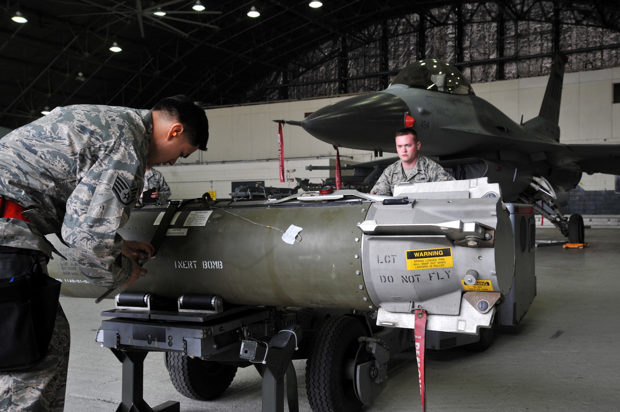 Staff Sgt. Jose Morin, left, and Airman 1st Class Douglas Edmondson, 36th Aircraft Maintenance Unit weapons loaders, prepare to lift a the CBU-103 bomb to load it onto a F-16 Fighting Falcon during the quarterly weapons load crew competition at Osan Air Base, Republic of Korea, April 5, 2013. Once a quarter, Airmen compete against each other during the competition where they are evaluated on safety, reliability, and technical errors. (U.S. Air Force photo/Staff Sgt. Emerson Nuñez)