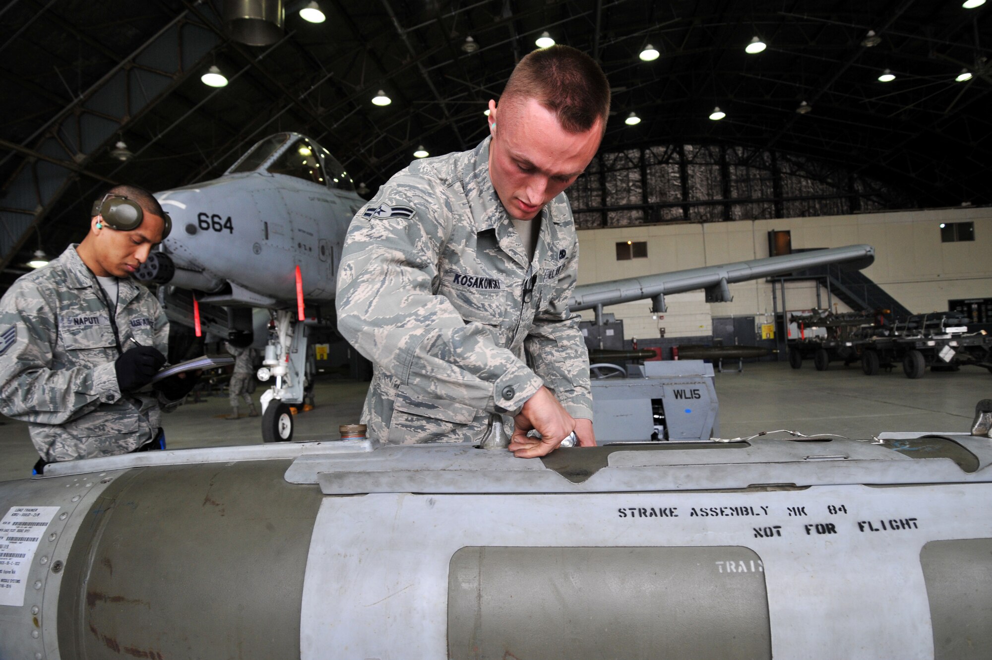 Airman 1st Class Nikolaus Kosakowski, 25th Aircraft Maintenance Unit weapons loader, ensures the CBU-103 bomb is ready to be loaded to the A-10 Thunderbolt II during the quarterly weapons load crew competition at Osan Air Base, Republic of Korea, April 5, 2013. Evaluators inspected two teams as they loaded munitions. (U.S. Air Force photo/Staff Sgt. Emerson Nuñez)