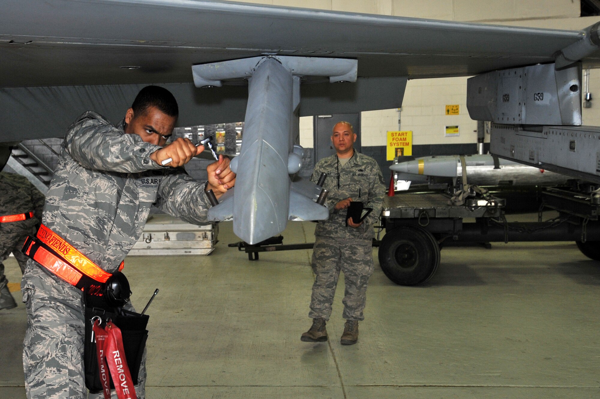 Senior Airman Dwight Hunter, 36th Aircraft Maintenance Unit weapons loader, prepares an F-16 Fighting Falcon for a GBU-31 bomb to be loaded during the quarterly weapons load crew competition at Osan Air Base, Republic of Korea, April 5, 2013.  Load crew competitions promote a safe competitive environment where Airmen display their skills and ability to apply what they’ve trained for.  (U.S. Air Force photo/Staff Sgt. Emerson Nuñez)