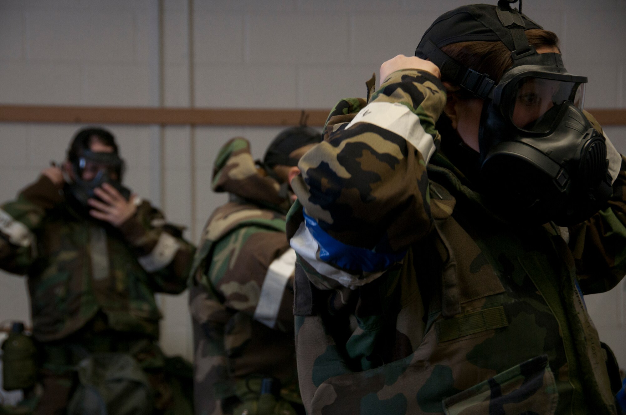 Members of the combined-forces emergency medical support team don their gas masks for a simulated chemical attack at Joint Base Elmendorf-Richardson April 7, during Exercise Polar Force 13-3. The readiness exercise is designed to validate the wing's ability to integrate, mobilize, and prepare assigned personnel, aircraft and equipment for their wartime mission and to employ forces and weapons systems to perform their assigned tasked missions. (National Guard photo by Staff Sgt. N. Alicia Goldberger)