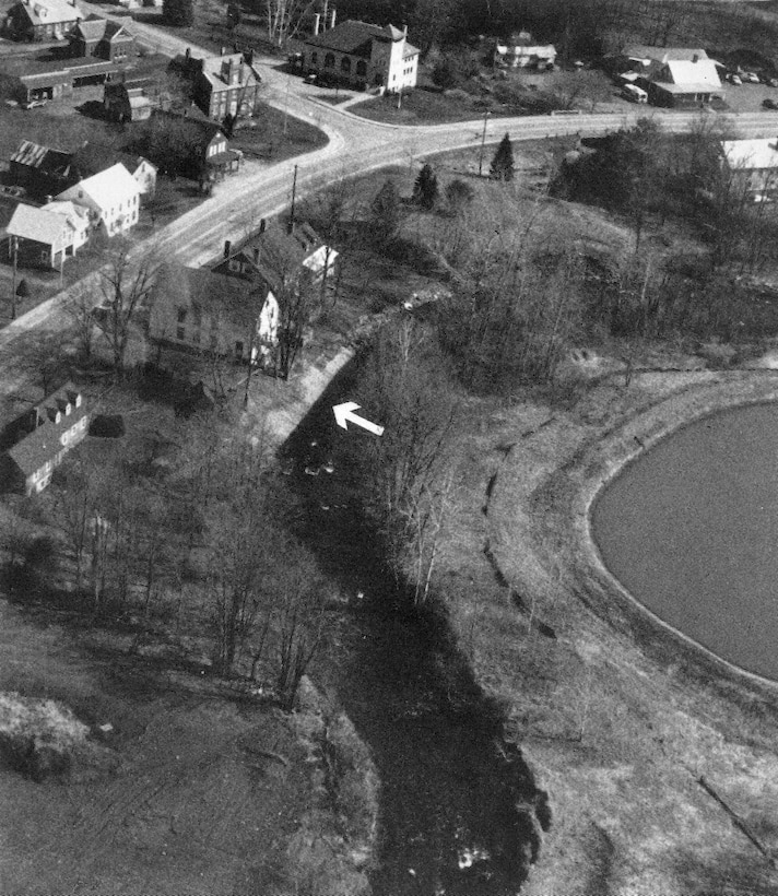Aerial view of Mill Brook shore and bank protection project. The project on Mill Brook is situated along the brook's northern bank in the Brownsville section of West Windsor, about 12 miles north of Springfield. The project lies adjacent to Gleanor Grange Hall in West Windsor's Historical District, about 150 feet upstream of the junction of Mill and Beaver Brooks in Brownsville, VT.