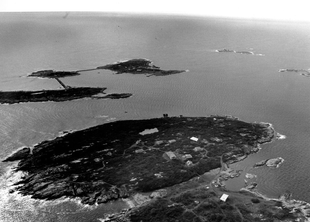 Aerial view of isles of Shoals Navigation Project.  Located off the coast of New Hampshire and Maine. Bisected by the boundary line of Rye, New Hampshire, and Kittery, Maine, the Isles of Shoals are about five miles east of Rye Harbor. Four of the islands - Star, Cedar, Smuttynose, and Malaga are situated such that they afford a small harbor, known as Gosport Harbor, NH.  Photo was taken in Dec. 1987.