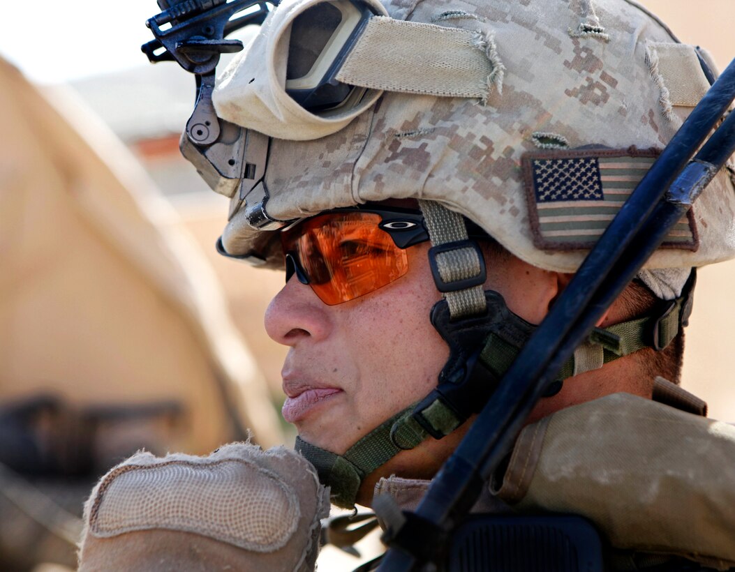U.S. Marine Corps Cpl. Martin Kim provides security as Afghan uniform police and Marines patrol through the bazaar near Afghan Uniform Police Outpost Mamuriyet in the Kajaki district in Afghanistan's Helmand province, April 1, 2013. Kim is assigned to the U.S. Marine-led Kajaki Police Advisor Team.