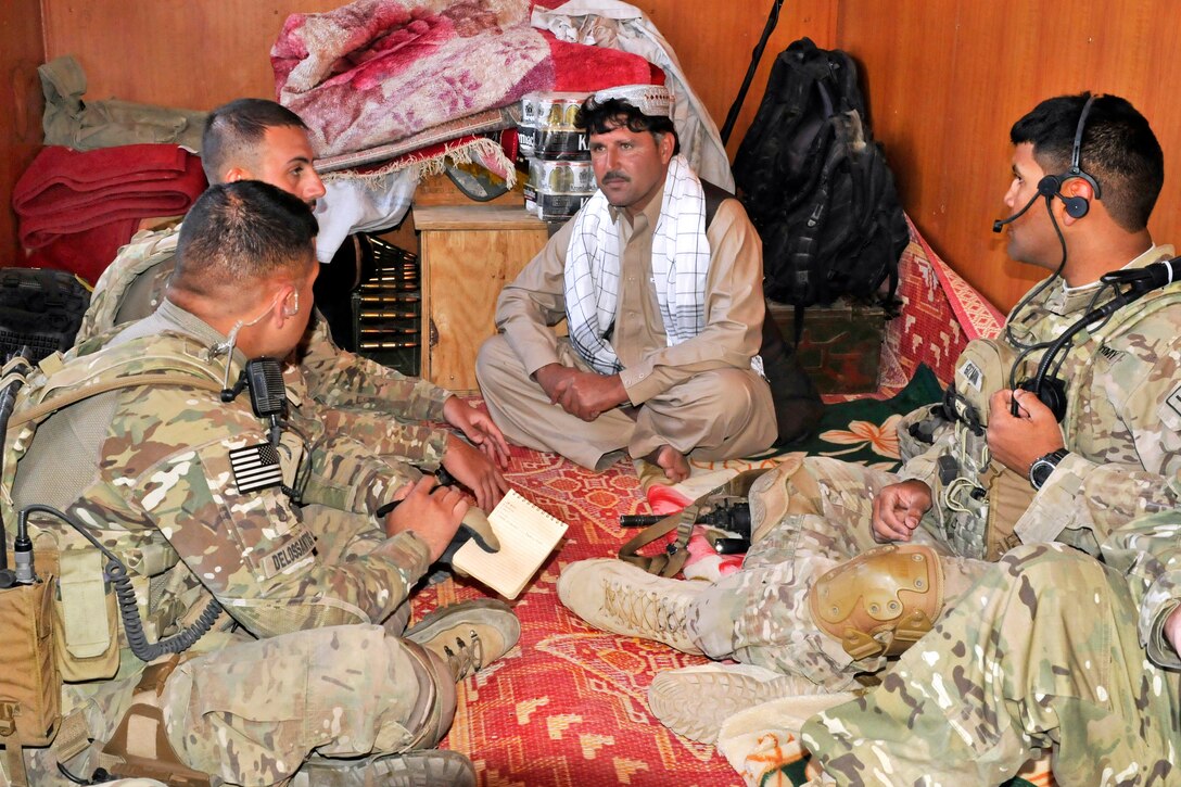 U.S. soldiers and Albanian special operations forces meet with leaders of an Afghan border police checkpoint near the Afghanistan-Pakistan border in the Spin Boldak district of Afghanistan’s Kandahar province, April 1, 2013.