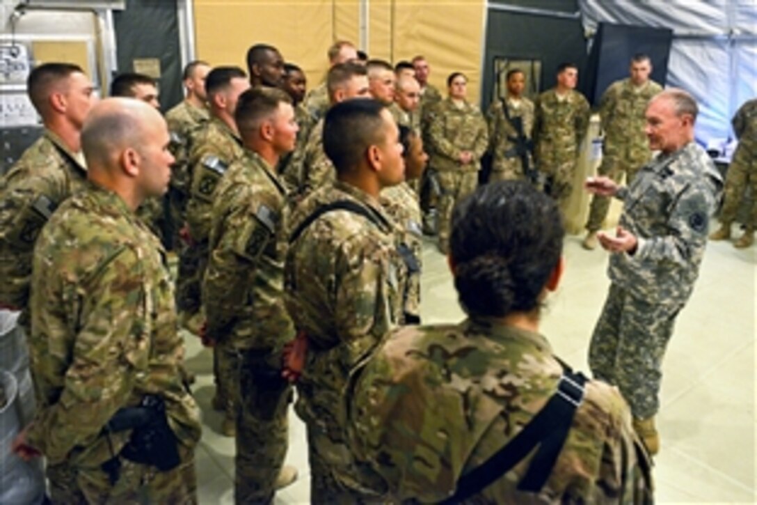 U.S. Army Gen. Martin E. Dempsey, chairman of the Joint Chiefs of Staff, talks with service members on Forward Operating Base Sharana in Paktika province, Afghanistan, April 7, 2013. 