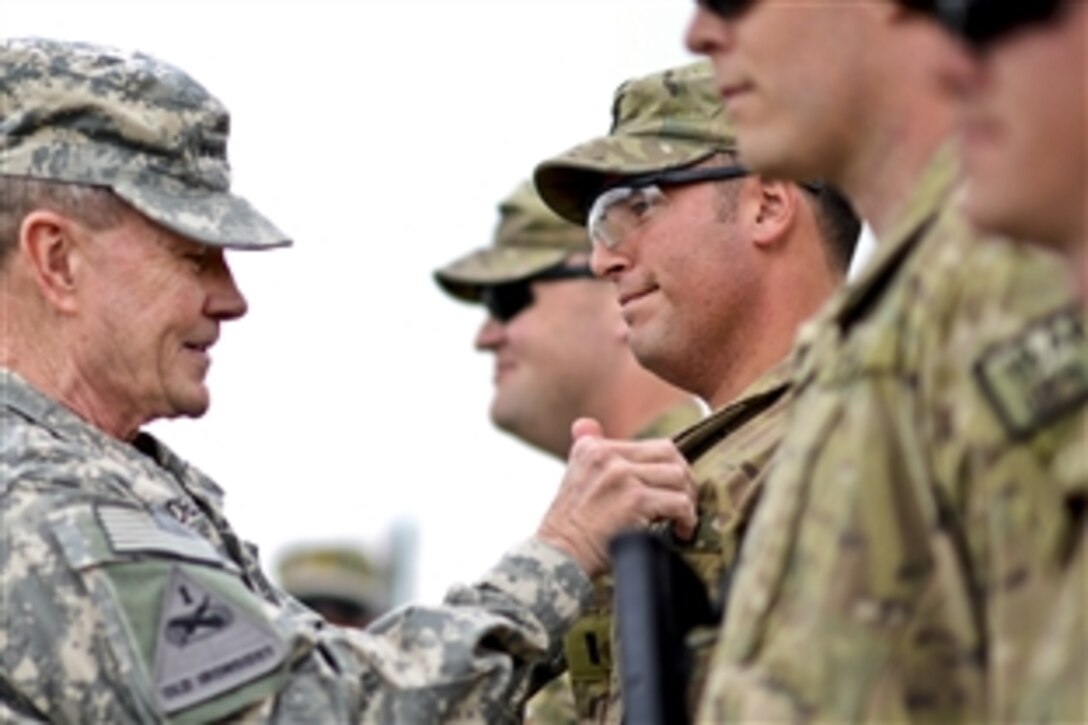 U.S. Army Gen. Martin E. Dempsey, chairman of the Joint Chiefs of Staff, presents awards to service members on Forward Operating Base Sharana, Afghanistan, April 7, 2013.