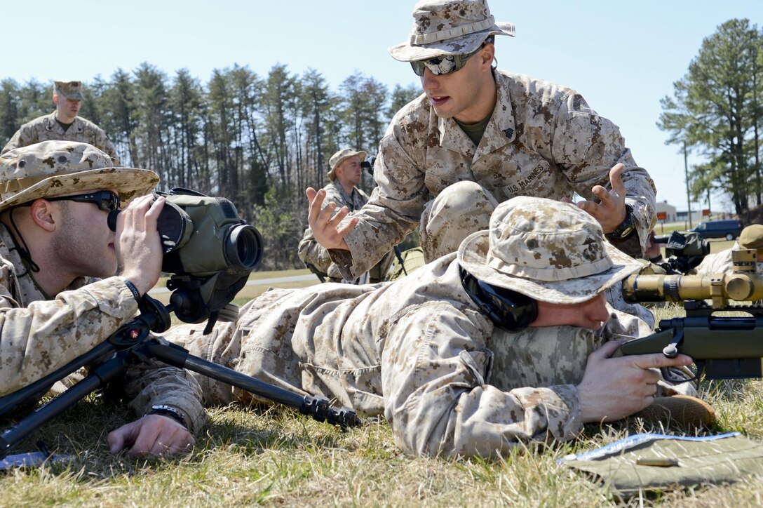 Sgt. Tony Dugan, team leader, Scout Sniper Platoon, talks to two Marines about their current scenario before the shoot during a training event at Weapons Training Battalion aboard Marine Corps Base Quantico on April 6, 2013. The Marines were conducting the known-distance qualification course.
