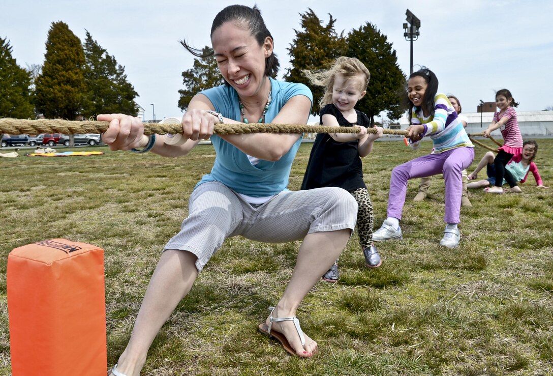 Vanessa Mckee, family readiness officer, Officer Candidates School, takes the front position for her tug of war team during  OCS’ Spring Fling event aboard Marines Corps Base Quantico on April 7, 2013.It was a two-hour event filled with back-to-back family competitions, a bake-off and an egg hunt. The competitions included a sack race, dizzy bat race, egg race, tug of war and a 3-legged race. There were also two moon bounces and a bubble machine for the younger children. “We are a tight knit family here,” said Col. Kris Stillings, commanding officer, OCS. “It’s been a tough couple of weeks and we thought that it was important to bring the families together. There is nothing that can heal people better than children laughing and having a good time.”