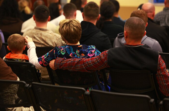 A servicemember with Combat Logistics Battalion 6, 2nd Marine Logistics Group sits with his family during a meeting with the battalion’s command aboard Camp Lejeune, N.C., April 4, 2013. More than 250 Marines, sailors and family members attended the meeting to gain information about the battalion’s upcoming deployment.