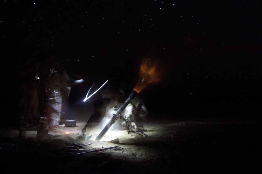 U.S. Marine Corps mortarmen assigned to Weapons Company, 3rd Battalion, 9th Marine Regiment (3/9), fire an M252 81 mm mortar system during a night fire mission on forward operating base Payne, Helmand province, Afghanistan, April 3, 2013. The Marines of 3/9 fired illumination mortar rounds in order to disrupt enemy activity. (U.S. Marine Corps photo by Cpl. Alejandro Pena/Released)   

